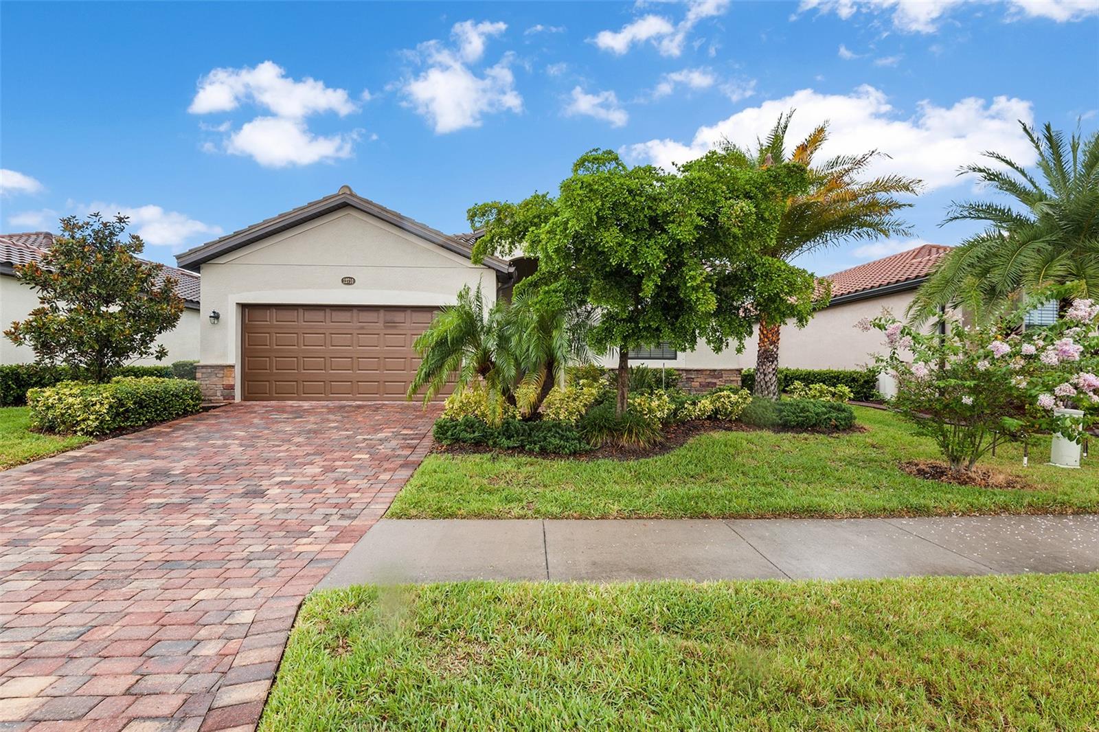 Great Opportunity to own in the highly sought after community of Gran Paradiso. This is not your average Capri Model! Situated on a premium water view lot with EXTREME VIEW LARGE custom lanai (with no see-um custom screening) with pavers. The upgrades are endless, some of which include 1 year old HVAC, New HW heater( (10 year warranty), full house water softener, all updated/upgraded appliances and new lighting fixtures.This well maintained home was built in 2017 includes 3 Bedrooms, 2 Bathrooms, and a 2-car garage. Once inside you will take note how clean this home is as you're greeted with volume ceilings. The primary bedroom and main living area have porcelain wood plank tile flooring. There is a spacious kitchen with granite countertops and stainless-steel appliances, and a very spacious kitchen eat-in area. The kitchen opens to a dining area that overlooks the great room. This split floor plan is perfect for guests and plenty of privacy. The guest bathroom is accessible from the lanai, a very nice addition if you want to add a pool! The Primary bedroom features a large CUSTOM walk-in closet and an attached bathroom that includes dual sinks, garden bath and walk-in shower. Gran Paradiso is a resort style community with a full-time activity director, zero entry pool, tennis, pickleball, basketball, sauna, hot tub, playground, clubhouse, miles of walking trails, and plenty of social opportunities to meet your neighbors. NO FLOOD INSURANCE required, and Ground maintenance included! Don't forget- the new Atlanta Braves Stadium is a short bike ride away-enjoy year-round events and activities. The new marketplace is now complete with PUBLIX, restaurants, shopping, gas station, etc!