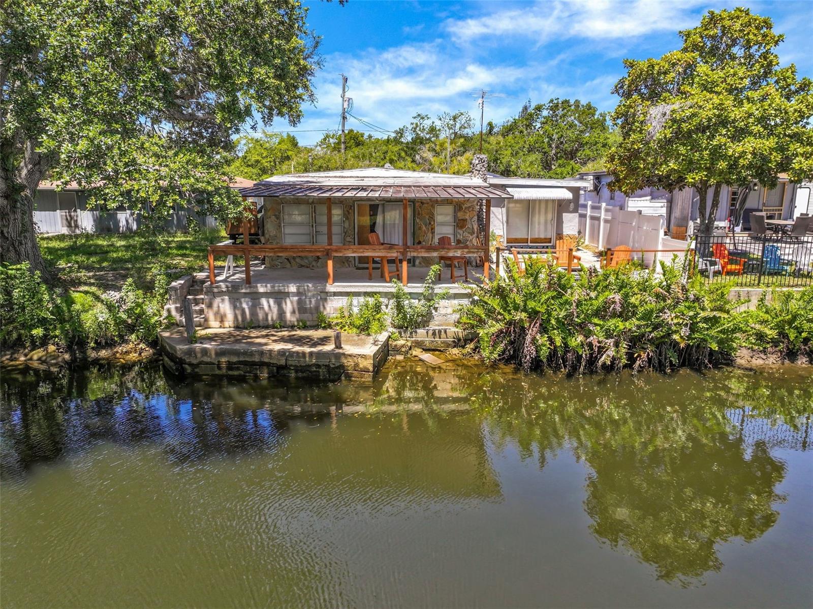 Investor Special – Direct Gulf Access Waterfront Opportunity in Hudson Beach!

Attention investors, builders, flippers, and waterfront dreamers! This hurricane-damaged waterfront property presents a rare opportunity to secure an affordable Gulf-access homesite in one of Florida's most popular boating communities. Damaged during Hurricane Helene flooding, this 2-bedroom, 1-bath home is being sold for land value and future potential. Whether you choose to renovate the existing structure, elevate the home, or start fresh with a brand-new coastal residence, the possibilities are endless.

Situated on a spring-fed canal with 45 feet of concrete seawall, this property offers direct access to the Gulf of Mexico through a fixed bridge under Old Dixie Highway. A nearby magnitude-two spring pumps millions of gallons of crystal-clear freshwater into the canal system, creating a unique mix of fresh and saltwater that attracts an abundance of marine life. Enjoy watching dolphins and manatees swim past your backyard while fishing for redfish, snook, trout, and snapper right from your seawall.

Properties with Gulf access at this price point are becoming increasingly difficult to find, making this an exceptional opportunity for investors seeking rental income, a future vacation home, seasonal retreat, or redevelopment project. The lot offers the chance to design a custom waterfront home tailored to your boating lifestyle while capitalizing on the continued demand for Gulf Coast waterfront properties.

Located in the heart of Hudson Beach, you'll enjoy a laid-back Old Florida coastal atmosphere where boating, fishing, and waterfront living define everyday life. Marinas, waterfront tiki bars, seafood restaurants, and the public beach are all just minutes away. Boaters can easily reach Anclote Key, Anclote Key State Park, Hernando Beach Flats, Weeki Wachee, Homosassa, and Crystal River for endless days of island hopping, fishing, scalloping, and exploring Florida's Nature Coast.

Conveniently located near US-19, shopping, restaurants, medical facilities, and everyday services are just minutes away. Tampa International Airport is approximately one hour south, while Orlando's world-famous attractions are within a 90-minute drive.

Being sold As-Is, Where-Is, and How-Is. Cash, Conventional Rehab Loans, or Hard Money Financing Only. No site-unseen offers and no assignable contracts. Buyers are responsible for verifying all information and completing their own inspections and due diligence.

Don't miss this opportunity to create value and build your vision on Florida's Gulf Coast waterfront.
