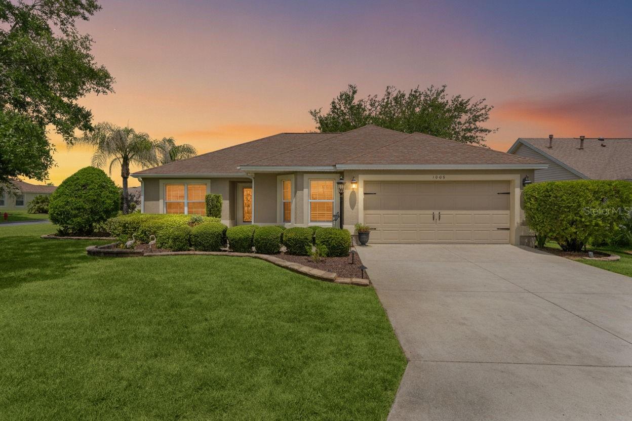 Welcome home to this beautifully maintained 3-bedroom, 2-bathroom block and stucco Jasmine model in the highly desirable Village of Mallory Square. Situated on a premium corner lot, this gently lived-in home has been meticulously cared for and is offered TURNKEY with tasteful furnishings, making it truly move-in ready. The popular split floor plan seamlessly blends comfort and functionality, featuring plantation shutters, tile plank flooring, and vaulted ceilings throughout. The well-appointed kitchen offers stainless steel appliances, gas cooking, granite countertops, a cozy breakfast nook, and abundant cabinetry for storage. The spacious primary suite includes a large walk-in closet and an en-suite bathroom complete with dual vanities and a Roman shower. The guest wing provides privacy for family and visitors with two generously sized bedrooms, a shared guest bathroom, a convenient pocket door, and a versatile Murphy bed with a built-in desk.
Enjoy year-round relaxation in the temperature-controlled lanai, featuring a mini-split air conditioning system, pull-down shades, and mature privacy landscaping. Ideally located, this home is surrounded by championship golf courses, recreation centers, and swimming pools, while being just moments from shopping, dining, and nightly entertainment at Sumter Landing Market Square, as well as the Mallory Hill Country Club. Don’t miss this exceptional opportunity—schedule your exclusive showing today!