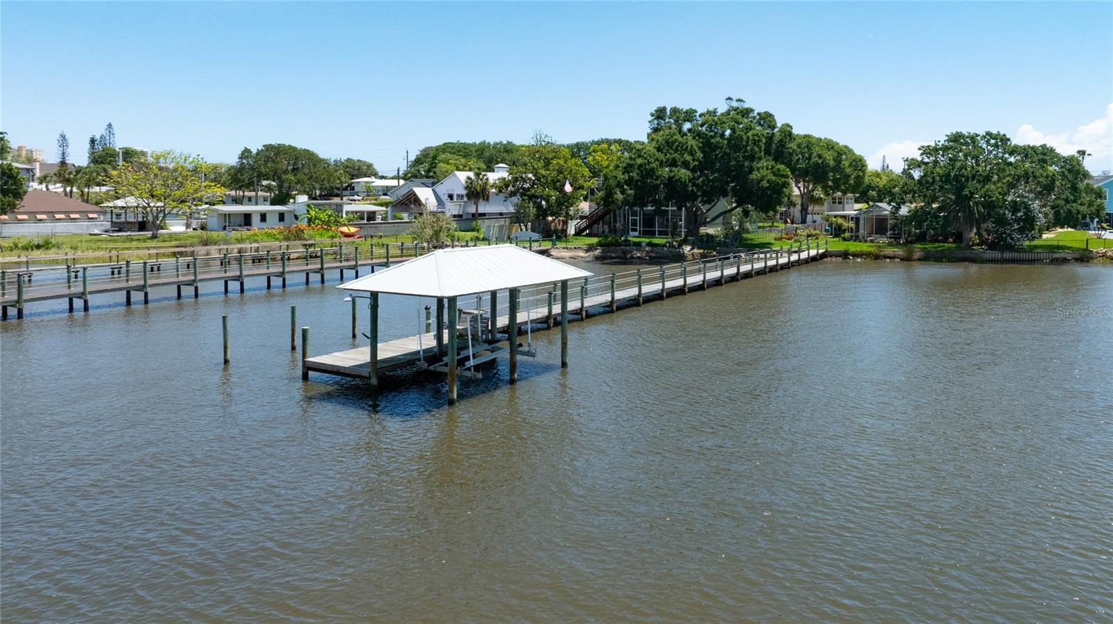 Stunning direct riverfront pool home on the Halifax River offering breathtaking sunsets, incredible water views, and the ultimate Florida lifestyle. This beautifully maintained estate property features a 3 bedroom, 2 bath main home plus a detached studio apartment with private entrance, ideal for guests, extended family, rental income, or a home office. Inside, you will find gorgeous wood flooring, plantation shutters, storm windows, and a beautiful stone fireplace that adds warmth and character to the living space. The updated kitchen is designed for entertaining with quartz countertops, stainless steel appliances, tiled finishes, and a spacious pantry.

The primary suite offers private sliders leading directly to the screened pool and backyard retreat. Multiple sliders throughout the home create seamless indoor and outdoor living while showcasing stunning river views. Step outside to your private waterfront paradise complete with a dock, boathouse, and electric boat lift. Relax poolside, enjoy dinner by the water, or watch dolphins and manatees play as boats cruise along the Intracoastal.

Located on North Halifax Avenue, this 1953 riverfront gem combines timeless charm with modern updates and offers an exceptional opportunity to enjoy waterfront living just minutes from the beach, dining, shopping, and entertainment.