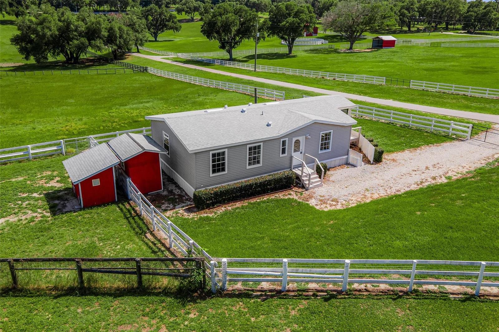 ROOM TO ROAM ON 6 ACRES! Experience the freedom of country living with no HOA and a prime location just minutes from The Villages. Bring your horses, cattle, chickens, and outdoor dreams—this agriculturally zoned, fully fenced and cross-fenced property is ready for it all. Enjoy breathtaking sunsets, gentle evening breezes, and peaceful pasture views from the screened front porch. Inside, the popular great room design offers an inviting space for gathering, while the spacious kitchen features abundant cabinetry and a center island perfect for entertaining. The seller will provide a brand-new private well prior to closing, adding even more value and peace of mind. Don't miss this rare opportunity to own your own slice of Florida countryside—schedule your private showing today and start living the lifestyle you've been dreaming about!
