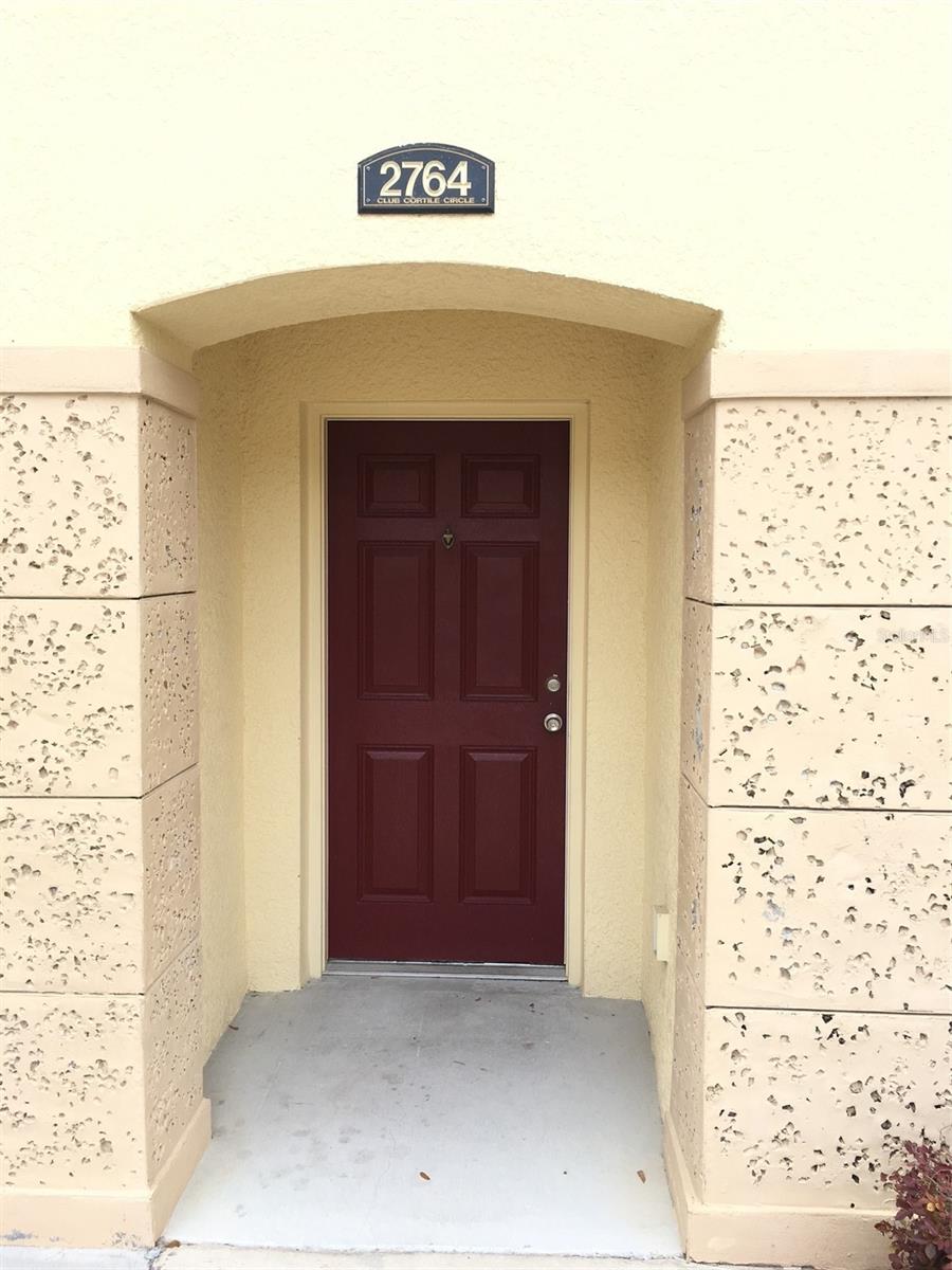 Located in a 24-hour gated community near Disney Theme Parks, this 2-story townhouse is FULLY FURNISHED, freshly painted, for a turnkey purchase. It is perfect for a primary residence, vacation getaway or even a rental opportunity. The functional layout begins with a downstairs bedroom and is ideal for anyone who prefers not to tackle stairs. Adjacent to the bedroom is a full bathroom featuring two separate access doors. One connects directly to the bedroom creating a private ensuite option, while another door opens to allow convenient use for guests and family. A seamless layout uniting the formal dining room, living area, and kitchen is perfect for today's lifestyle. The kitchen is fully equipped and includes an island with seating for 2. Just off the living room are sliding doors leading to a screened-in lanai with no rear neighbors. To complete the downstairs is a sizeable laundry room with washer/dryer. Journey upstairs to a spacious owner's suite. The large walk-in closet provides ample storage and the ensuite bathroom features dual split sink vanities, private water closet, garden tub and separate shower. Just down the hall are 2 additional bedrooms and full bathroom. This popular community offers a refreshing pool, fitness center, playground, tennis and basketball courts. Conveniently located near major roadways and an array of shopping and restaurants.