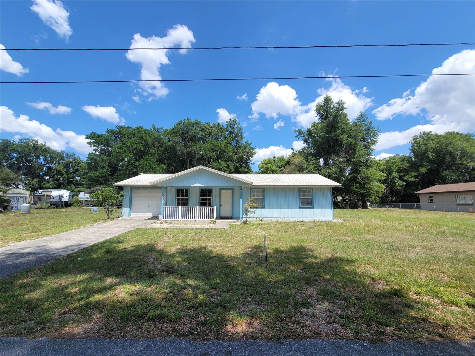 Affordable and well-located 3 bedroom, 2 bathroom home on approximately .58 acres in Coleman with NO HOA or CDD. This single-story home offers 984 sq ft of living space, an attached 1-car garage, covered front porch, fenced yard, and a 24x25 workshop with RV hook up—perfect for storage, hobbies, tools, equipment, or keeping the toys tucked away. Inside features include central heat and air, ceiling fans, eat-in kitchen space, laundry in the garage, and a practical layout with room to make it your own. Convenient location near The Village of Fenney, US-301, I-75, Florida’s Turnpike, shopping, restaurants, medical facilities, Ocala, Tampa, Orlando, and The Villages. A great option for a primary residence, investment property, or anyone needing extra yard and workshop space without the restrictions of an HOA. Buyer and buyer’s agent to verify all measurements, utilities, zoning, restrictions, and property details. More pictures will be posted soon.