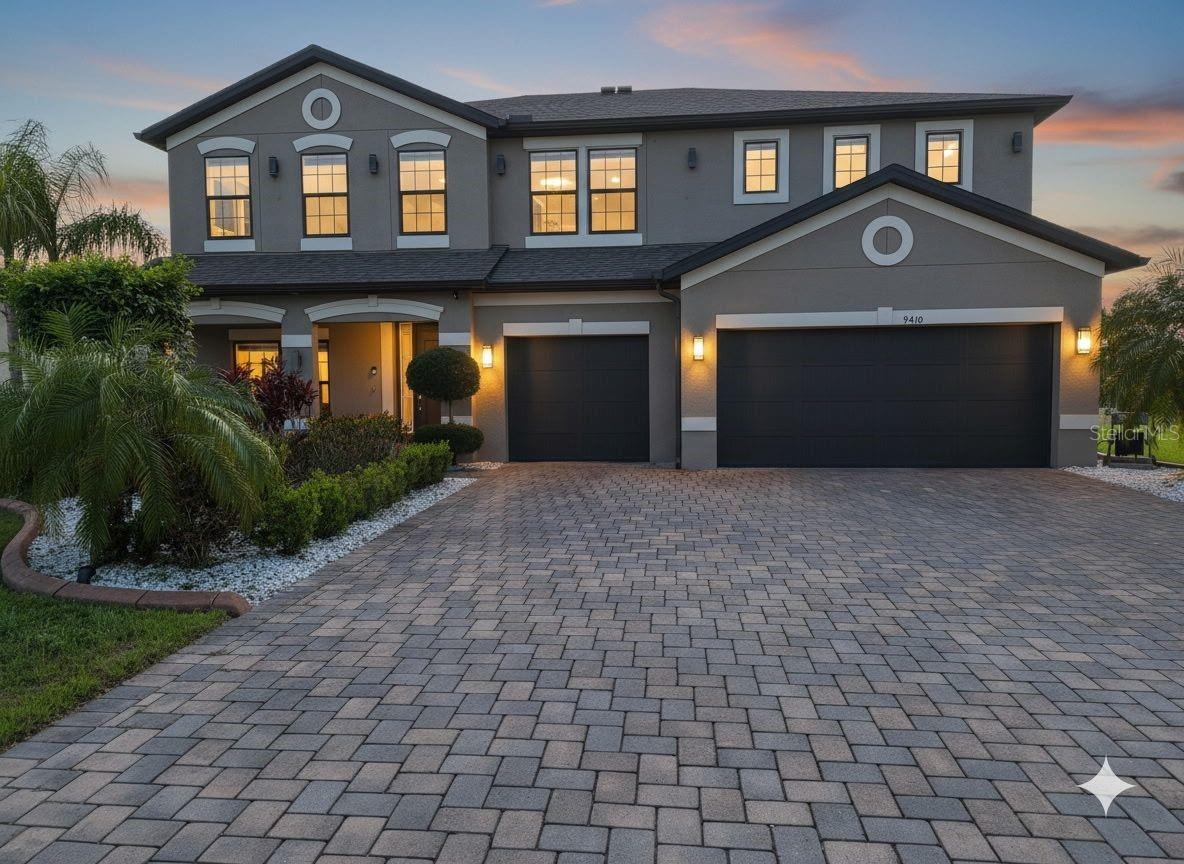 Prepare to be wowed. This extraordinary 5 bedroom, 3 bath luxury home sits on an oversized water-view lot in an exclusive, highly sought after Gated Community just 20 minutes from Tampa. Offering the kind of presence and elegance that stops buyers in their tracks. The two-story foyer makes a jaw-dropping first impression, leading to a chef-inspired gourmet kitchen and spacious living areas framed by sleek 8' interior doors and large windows flooding the space with natural light.
Every detail has been elevated — roof gutters, whole-home water softener, irrigation well, 3-car garage with upgraded insulated garage doors, and a pavered driveway that sets the tone before you even step inside.
This is true Florida Luxury. Save it, Love it, Schedule it!  Come and experience it for yourself!