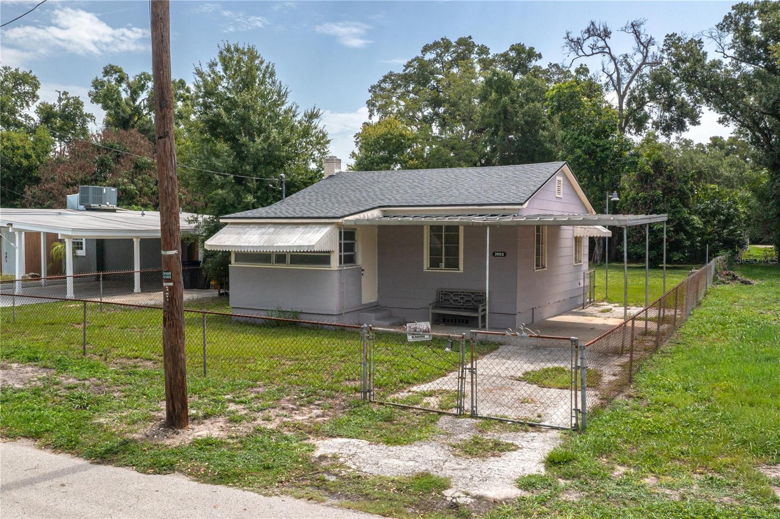 Virtually Staged. Discover an exceptional opportunity in the heart of Tampa Heights, one of Tampa's most rapidly evolving neighborhoods.  Located at 3905 N. Clearfield Avenue, Tampa, FL 33603, this charming 2-bedroom, 1-bath bungalow is currently undergoing a full renovation, giving buyers the rare opportunity to customize and complete the remodel to their own style and vision. A new roof was installed in 2025, providing a valuable head start on the renovation.  The spacious lot provides plenty of room to expand the existing home, add a detached garage, or explore the possibility of constructing an accessory dwelling unit (ADU) or mother-in-law suite (subject to local zoning and permitting).  For those seeking to build new, this oversized homesite offers outstanding redevelopment potential in an area surrounded by impressive new construction and thoughtfully restored historic homes.  Conveniently located just minutes from I-275, I-4, Downtown Tampa, Armature Works, and the Tampa Riverwalk, you'll enjoy quick access to some of the city's best dining, entertainment, and employment centers.  Less than 3 miles to Raymond James Stadium and under 5 miles to top rated medical facilities and hospitals!  Outdoor recreation is just one block away at Calvin Taylor Park, featuring baseball fields, basketball courts, playground, and the Taylor Art Studio. Best of all, the property is not located in a flood zone, offering added peace of mind.  No HOA!  Whether you're an investor, builder, or buyer looking to create your dream home, this is an exceptional opportunity to own property in one of Tampa's fastest-growing neighborhoods.