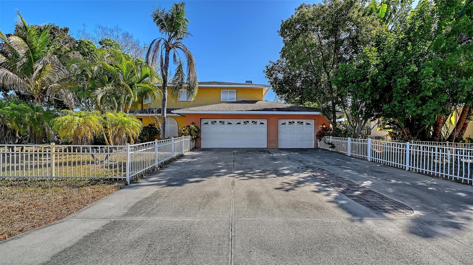 This MULTI-GENERATIONAL home has a total of four bedrooms with Two Primary Suites located on both the 1st and 2nd floors. Two additional upstairs bedrooms share a full bath with a tub. The ample Foyer with Cathedral Ceilings leads to the Open Living & Dining area; and the 15’ x 21’ Family Room with fireplace. A Den with murphy bed and a half bath are adjacent to Foyer. The enclosed porch opens to a covered patio and a spiral staircase leading to the roof deck above the first-floor Primary. 
Seller offering credit of up to $10,000 towards repairs & improvements.  The hot tub is ready, and the laundry room plus 3-car garage offer ample storage. Repairs to roof deck surface to be scheduled for July. This home is conveniently located to the beaches, schools, shopping, and downtown Sarasota.