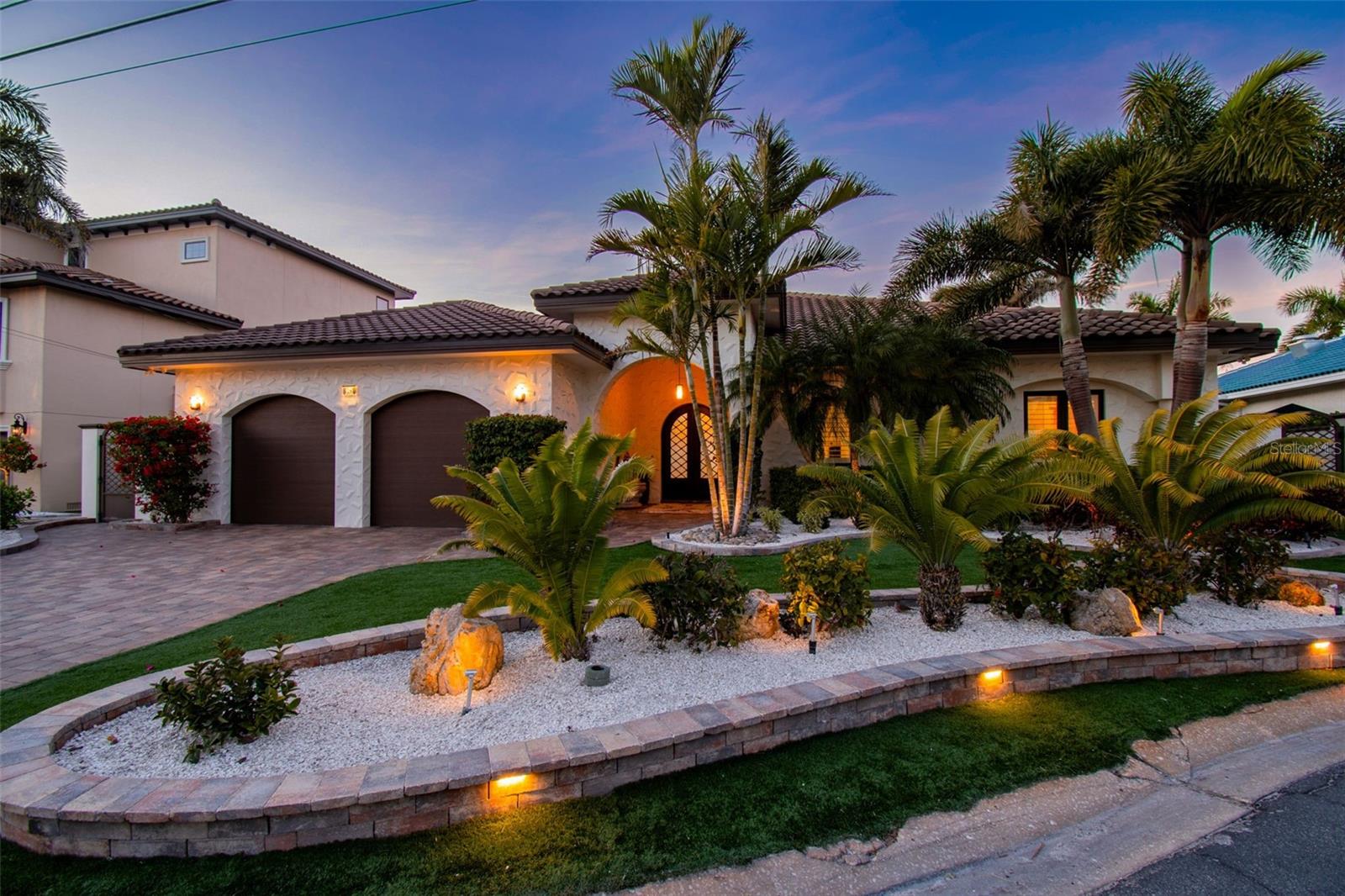 Discover your own slice of paradise at this exquisite waterfront haven where elegance, glamour and serene comfort come together in the heart of sunny St. Pete Beach. Tucked away on a quiet cul-de-sac in the coveted Brightwater Beach Estates—a desirable enclave where every home is waterfront—this renovated residence exudes effortless coastal sophistication.
Step inside and be captivated by expansive, breathtaking views of Boca Ciega Bay. This elegant residence exudes timeless coastal glamour and serene comfort, blending sophisticated designer touches with an open-concept living space perfect for relaxed Florida living and gracious entertaining. Soaring 10- and 12-foot ceilings throughout, accented by 8-inch baseboards, travertine flooring throughout, and classic plantation shutters set the stage for refined living. The layout is designed for both everyday comfort and gracious entertaining, centered around a generous kitchen island and complemented by stainless steel appliances, including a new Fulgor gas range and Bosch dishwasher (2025). Designer touches shine throughout the home, offering three spacious bedrooms, four full bathrooms, ample storage and a generous laundry room finished with granite countertops. The home has been thoughtfully updated and was not deemed significantly damaged in the most recent storms.
Step outside to a boater’s paradise with 90 feet of prime waterfront overlooking Boca Ciega Bay. Enjoy a deep-water dock with a wet slip, a 12,000-lb boat lift, dedicated dual jet-ski lift and a newer seawall (2020). Outdoor living is elevated with a fully equipped kitchen featuring granite countertops, built-in stainless gas BBQ, bar refrigerator, sink, and abundant storage—perfect for sunset gatherings. The pool is supported by new equipment, including a natural gas heater and pump (2025), ensuring year-round enjoyment.
Located in a tranquil neighborhood with no through traffic and just a short stroll from world-renowned white-sand beaches, acclaimed dining, charming shops, and breathtaking sunsets, this turnkey waterfront gem combines luxury, privacy and location in one of Florida’s most desirable beach communities. For frequent travelers, Brightwater Beach Estates is only a short 20 minute drive to St Pete-Clearwater International Airport, 35 minutes to Tampa International Airport and 10 minutes to the I-275. Don’t miss this opportunity to own a piece of St Pete Beach paradise!