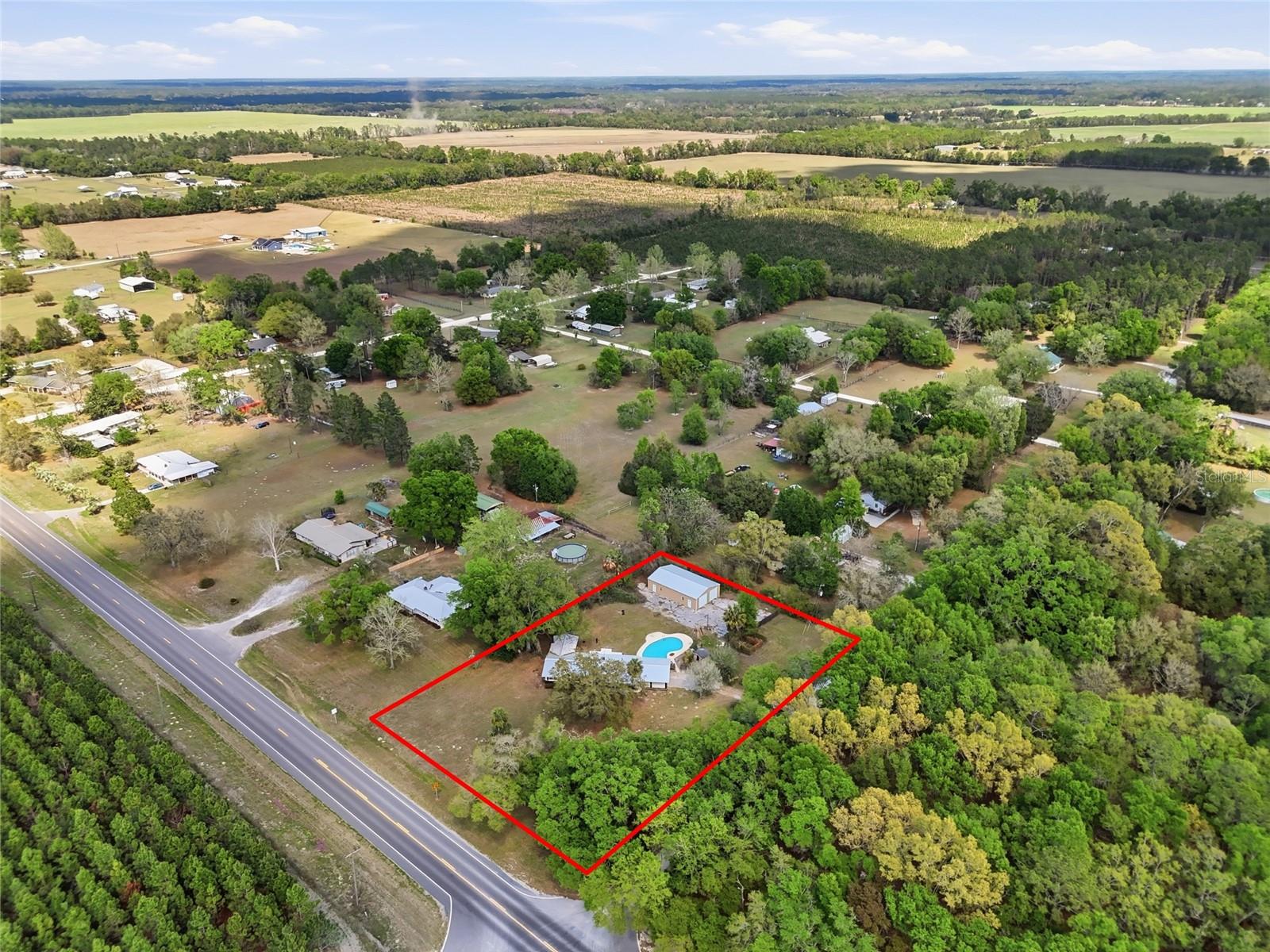 Fully renovated POOL home situated on a corner lot just under 1 acre in Gilchrist County featuring major recent improvements including a new roof (2025), new HVAC (2025), and new septic drain field. Interior updates include a completely remodeled kitchen and bathroom, new flooring, fresh interior paint, and updated appliances throughout.  The property also features a beautiful in-ground pool, a large detached workshop, and a wood-fenced backyard providing space for storage, hobbies, animals, or outdoor enjoyment. The spacious lot offers privacy and flexibility with room for additional parking, equipment, or recreational use.  Move-in ready and conveniently located within a short drive to Trenton, High Springs, and Gainesville.