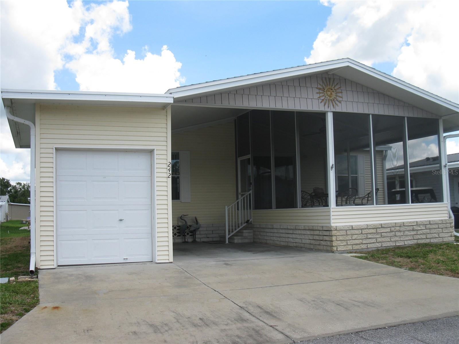 This 2005 3 Bedroom Palm Harbor home has a great floor plan.  Nice front porch and a golf cart garage.   Roof is only 3 yrs old.  Furnished with golf cart.  All located on your own deeded lot in a gated golf and tennis community.  You will love all amenities this community has. Heated poo with lounge chairs, umbrella tables, bathrooms and dressing rooms, hot tub spa, fitness center, tennis court, pickle ball court, 18 hole executive golf course, pro shop, shuffle board, horse shoes, bocci ball court, Lakefront with screen gazebo, BBQ grill, firepit, fishing, kayak rack, boat slips, and full Service Pub in our beautiful clubhouse with billiards, indoor shuffle board, library, craftroom, ballroom, and a full service Pub.   We are a very active and fun community, see us before you buy, you will glad you did.