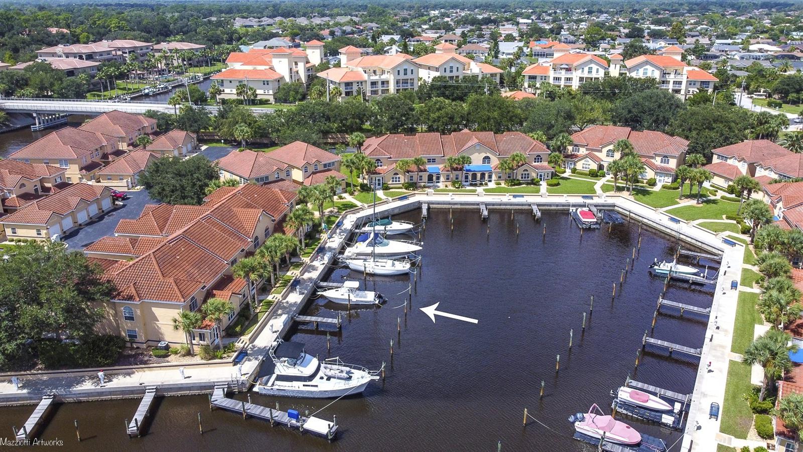 NEW PRICE! Motivated Seller! This price now includes Slip 48B, directly in front of the unit. Come enjoy the boating lifestyle that awaits you at Marina Cove. This professionally staged 2/2 waterfront home with upstairs loft, offers the perfect fusion of serene water views and a sensational year-round retreat. Whether you choose to make it your personal oasis or a rental investment, you'll enjoy the boating lifestyle it offers. Arrive home to the convenience of a 1-car garage, and a brand NEW water heater and NEW roof. Unwind each night in the inviting downstairs owners suite, boasting views of boats and tranquil waters. The ensuite bathroom indulges your senses with a spacious soaking tub, and a tiled walk-in shower. The kitchen has undergone a marvelous upgrade, showcasing newer appliances and granite counter and tile backsplash.  For your convenience a full-size washer/dryer combo convey. Upstairs there is another good sized bedroom and full bathroom. The loft, transformed into a private haven, offers a full-sized closet and serves as a versatile space that can double as a guest bedroom but also lends itself perfectly to be a cozy den or library. Every day spent in your condo will feel like an everlasting holiday in paradise as you unwind on your delightful enclosed patio, savoring the sights and sounds that accompany marina living.  Enjoy the abundant amenities provided by the HOA: Building maintenance/paint, water, sewer, trash, and access to an array of recreational activities, including pickleball, tennis, and bocce. Or enjoy afternoons at the pool. Delight in strolls along the Intracoastal Waterway, and main canal  Imagine the convenience of having your boat just steps away from your patio. Marina Cove stands tall as Palm Coast's premier boating community, secured within gates and positioned in flood zone X.