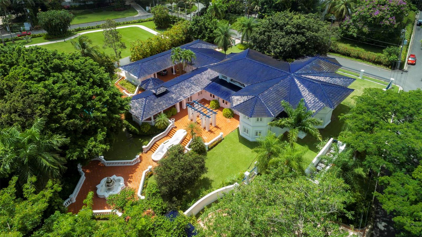 This home, located in the esteemed San Patricio Estates, is a masterpiece of luxury and design. Built in 1994 by renowned architects Ricardo Jimenez-Barceló & Jimenez Associates, this property offers an ample 9,310 sq.ft. of gross area and is situated on 1.3 acres of beautifully landscaped land. 

This grand estate encompasses six (6) bedrooms, six (6) full bathrooms, and two (2) powder rooms. The primary bedroom wing is particularly impressive, featuring two spacious wardrobe rooms adorned with cedar-lined closets and an office room. The en-suite bathroom showcases exquisite fixtures and vanities from the renowned Sherley Wagner collection. 

This exceptional residence combines a range of luxurious amenities. The interior boasts a grand foyer, double-height ceilings in the living and formal dining room, a chef's kitchen with top-of-the-line appliances, a family room, wine cellar, library room with a kitchenette, maid’s quarter, and laundry room.

Outside, there are extensive covered and open terraces, a bar and gazebo, storage rooms, a covered carport for six (6) cars, and a pool and jacuzzi with a water heater. The attention to detail is evident with pristine Italian marble floors throughout, Terracota blue roof tiles, plastered walls, security windows and doors, a 150 KW emergency power generator, a water sub-station, a water cistern, and water softener.