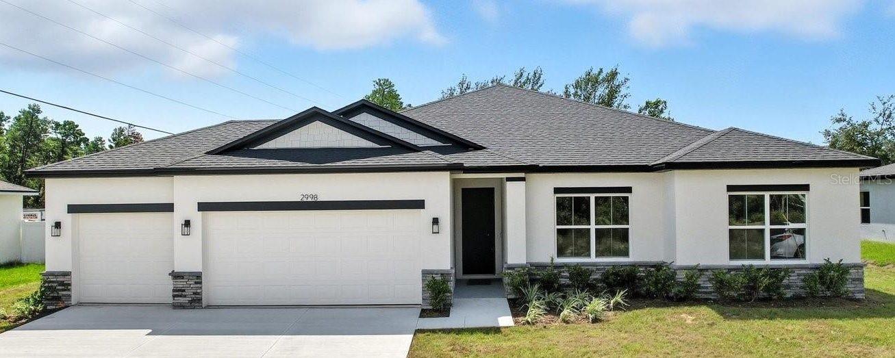 Virtually Staged. Under Construction. Under Construction – The Everglade. This 4-bedroom, 3-bath home—available with a 3-car garage—features a wide-open, light-filled floor plan enhanced by soaring vaulted ceilings. A welcoming covered entry and spacious covered lanai extend the living area outdoors, ideal for enjoying Florida’s warm breezes. Summit Homes Florida includes the features today’s buyers expect, luxury vinyl plank and ceramic tile flooring throughout, 8-foot doors, 5¼-inch baseboards, a landscaped yard with irrigation, an interior laundry room, and a garage door opener. The kitchen is designed for both style and function, offering solid-surface counters with a tile backsplash, custom cabinetry with 42-inch uppers and soft-close doors and drawers, stainless-steel appliances, and a generous pantry. The large primary suite provides a relaxing retreat with a ceramic-tiled shower, dual sinks, a private commode room, and an impressive wrap-around walk-in closet for exceptional storage. Thoughtful details throughout the home highlight craftsmanship and quality, blending comfort, functionality, and lasting value. You won’t want to miss this one.