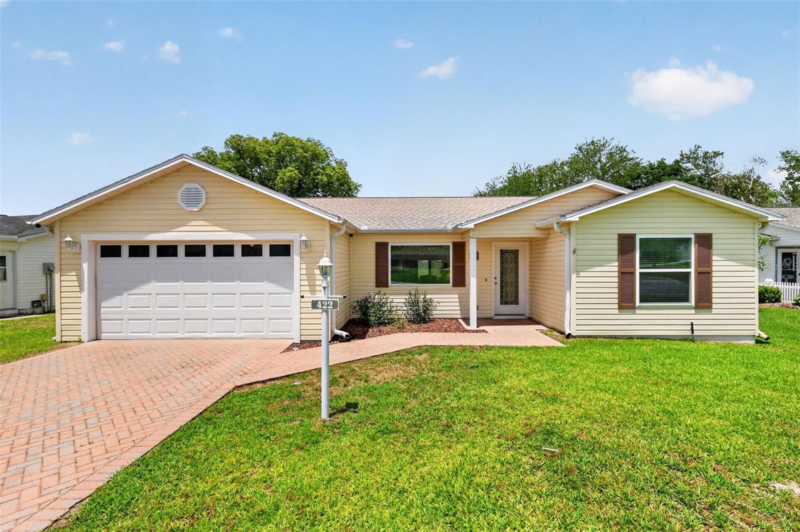 Exceptional Outdoor Living Awaits!  Discover a remarkable home situated on a Wildlife Wetland Preserve, offering breathtaking views and unparalleled privacy—an absolute rarity in The Villages. This meticulously maintained 3-bedroom, 3-bath Custom Austin model in the Village of Rio Ponderosa is ideally located between Lake Sumter Landing and Spanish Springs Town Squares. Enjoy the peace of mind that comes with a PAID BOND, a new ROOF (2026), WINDOWS (2019), and TURNKEY furnishings, including a 2013 YAMAHA GOLF CART. Plus, benefit from a 13-MONTH WARRANTY!  This residence boasts a spacious garage with a 14 ft garage door, paver driveway, and walkway, along with an open concept design featuring an additional third bedroom with an en-suite bath. Walk through the LEADED GLASS DOOR and step inside to find beautiful tile flooring throughout, a bright living room with a ceiling fan and large double pane picture window that invites natural light, and a dining area enhanced by a SOLAR TUBE that amplifies the warmth of the home.  The kitchen was thoughtfully designed as a wall was removed making this expansive kitchen with breakfast bar open and ideal for entertaining. The primary suite offers serene views of the wildlife preserve, complete with a ceiling fan, a WALK-IN CLOSET with shelving, and an en-suite bath featuring a WALK-IN SHOWER. The front guest bedroom also highlights a ceiling fan and a MURPHY BED, while the guest bath includes a convenient tub/shower combo and a linen closet in the hallway. An ADDED THIRD BEDROOM for guests showcases VAULTED CEILINGS, views of the wildlife preserve, a spacious CLOSET, and its own EN-SUITE BATH. Enjoy year-round entertaining in the 240 sq ft FLORIDA ROOM, featuring tile floors, a ceiling fan, a pass through to the kitchen, and sliding doors that lead to a 20x10 outdoor deck to enjoy the view of the wetlands with its many birds and beautiful sunsets. Ideally located between Spanish Springs and Lake Sumter Landing, this home offers easy access to dining, shopping, and medical facilities along 441 and 466, with proximity to the Tierra Del Sol Championship Golf Course - Recreation Center -Adult Pool, and also the Rio Grande and Chula Vista Recreation Centers. Don’t miss out on this exceptional opportunity for outdoor living at its finest!