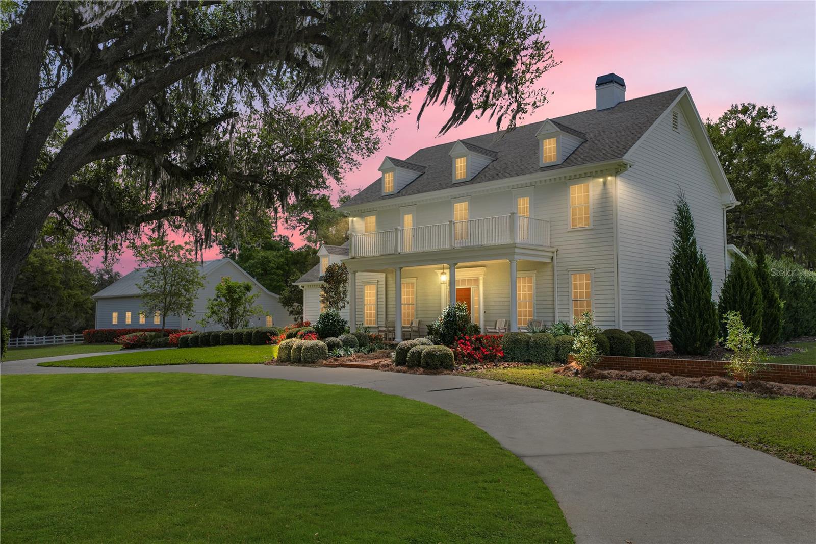 Refined Southern Elegance on 5 Private Acres. Experience timeless Southern charm and modern
luxury in this exceptional estate offering 3,608 heated square feet in the main residence and an
additional 1,000+ square feet guest retreat above the barn. Perfectly positioned on five
picturesque acres, this stunning property offers privacy, beauty, and endless possibilities for
equestrian living. From the moment you step into the grand foyer, the home showcases
impeccable craftsmanship with custom trim work, detailed moldings, rich hardwood floors, 9-
inch baseboards, and elegant 10-inch crown molding throughout the main level. The thoughtfully
designed floor plan balances sophistication and comfort, beginning with a formal parlor that
shares a fireplace with the inviting family room, creating a warm and elegant space ideal for
entertaining and cozy nights by the fire. A formal dining room sits just off the foyer, offering the
perfect setting for memorable dinners and celebrations. Throughout the home, abundant natural
light pours through expansive windows, highlighting the quality finishes and beautiful
architectural details. The heart of the home is the chef’s kitchen, featuring 42-inch maple
cabinetry, stone countertops, and an eat-in dinette, designed to blend functionality with timeless
style. French doors from the family room open to a screened porch surrounding the brick
accented outdoor living area and pool deck, creating a seamless transition between indoor
comfort and outdoor relaxation. Upstairs, four generous bedrooms utilize the newly renovated
bathrooms that add modern elegance while maintaining the home’s classic Southern character.
Beyond the home itself, the property unfolds into a truly remarkable setting. A charming cottage
garden filled with flowers, herbs, and vegetables creates a peaceful retreat, while a fenced area
with chicken coop adds to the property's country lifestyle appeal. The three-stall barn enhances
the estate’s versatility and includes beautifully finished guest quarters above, complete with an
entertaining space, three custom built-in beds, a full bathroom, and additional storage, perfect for
guests, extended family, or a private retreat. With five acres allowing horses, this extraordinary
property offers the opportunity to create a stunning equestrian estate while enjoying the elegance
of Southern living. A rare combination of luxury, privacy, craftsmanship, and lifestyle, this is
more than a home; it is a place to truly live.