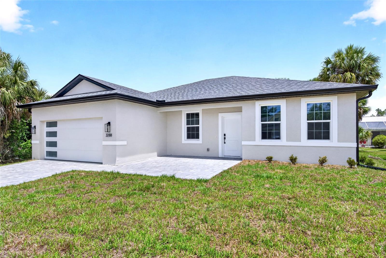 JUST COMPLETED! BRAND NEW 4 BEDROOM, 3 BATH, 2-CAR GARAGE HOME IN NORTH PORT! Stunning new construction home, designed with thoughtful details for comfort and style. Open floor plan with high ceilings, luxury vinyl flooring, contemporary and recessed lighting plus much more. Well-appointed kitchen offers soft-close cabinetry, quartz waterfall countertops, tile backsplash, stainless steel appliances, closet pantry and center island overlooking the dining and living areas. Generous primary bedroom with his and her walk-in closets and en-suite bath featuring dual sinks, LED mirror, and walk-in tile shower. Split floor plan provides guests with plenty of privacy, featuring 3 additional bedrooms, a full guest bath, and one bedroom with its own ensuite bath perfect for hosting guests or family. Outdoor entertaining area features covered lanai and plenty of room for a pool in the backyard. Additional highlights include impact windows and doors, smart thermostat, water filtration system, epoxy garage flooring, and paver driveway. Nestled on a quiet street you'll enjoy the peace of suburban living while still being just minutes away from shopping, dining, and everyday conveniences with easy access to I-75. With North Port's affordability, friendly atmosphere, and strong community feel it's easy to see why so many are choosing to call this area home. Don’t miss this opportunity! Schedule your private showing today!