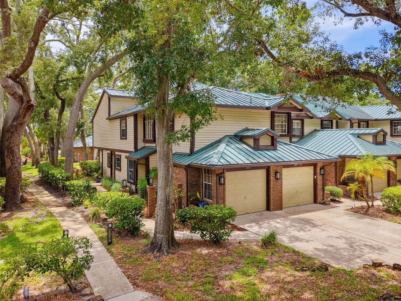 Move-In Ready Palm Harbor Condo with Garage, Fireplace & Resort-Style Amenities – No Flood Zone!
Welcome to this beautifully renovated 2-bedroom, 2-bath condo offering 1,353 square feet of stylish, move-in-ready living in one of Palm Harbor's most desirable locations.
Completely renovated in 2022, this exceptional home combines modern finishes with timeless comfort. The spacious kitchen features blue shaker-style wood cabinetry, quartz countertops, New Samsung stainless steel appliances, and abundant storage. Luxury vinyl plank flooring flows throughout the home, while the inviting living room is anchored by a cozy wood-burning fireplace—the perfect place to relax after a day at the beach or enjoy Florida's cooler winter evenings.
Both bathrooms have been beautifully updated, including a spa-inspired primary bath with a lighted vanity mirror. Major improvements have already been completed for your peace of mind, including a new metal roof (2023), new HVAC system (2025), and a new hot water heater to be installed prior to closing. An attached one-car garage with new epoxy flooring, provides additional storage and everyday convenience.
The community offers outstanding amenities, including a sparkling swimming pool, hot tub, tennis courts, barbecue grills, and peaceful walking paths shaded by majestic oak trees.  Cable TV, Internet, With no age restrictions and a pet-friendly policy allowing two pets, this community welcomes a variety of lifestyles.
The HOA provides exceptional value by covering the roof, water, sewer, trash, Cable TV, Internet, exterior building maintenance, grounds maintenance, pool maintenance, and pest control, allowing for truly low-maintenance living.
Located outside of a flood zone, you'll also enjoy direct access to the Pinellas Trail, with over 75 miles of scenic biking and walking paths. You're just minutes from Honeymoon Island State Park, Caladesi Island, and the charming downtowns of Palm Harbor, Dunedin, and Ozona, where you'll find waterfront dining, local breweries, boutiques, farmers markets, and year-round community events.
Whether you're looking for your first home, a seasonal Florida retreat, or the perfect place to downsize, this turnkey condo offers the ideal combination of quality updates, low-maintenance living, exceptional amenities, and an unbeatable Palm Harbor location. Simply move in and start enjoying the Florida lifestyle.