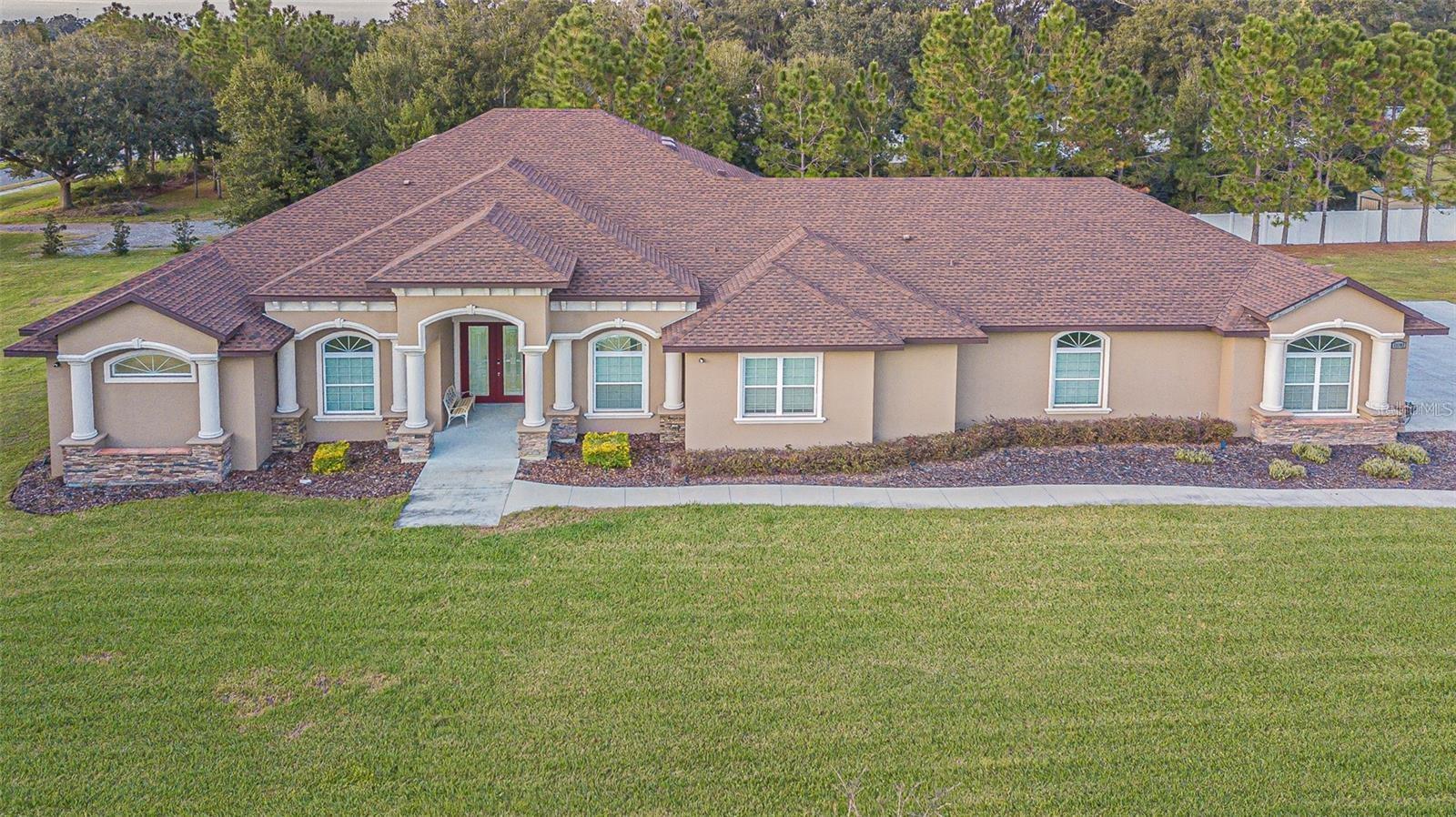 Price improved to reflect current market value. Long “Days on Market” reflects prior pricing, not condition. Sellers are motivated and welcome offers!!!
Welcome to 13102 Done Groven Dr. Dover. FL 33527! This exquisite 4676 saft home. boasting 4 bedrooms. 4 bathrooms and 4 car garage (1218 SF), is a true gem nestled on over 1 acre of land. Meticulously Designed Custom Built in 2021, this residence seamlessly combines modern luxury with spacious living. The heart of the home features a gourmet Chef's Palace Styled Kitchen complete with built-in stainless steel appliances, 42' cabinets, high end granite counter-tops elevating both style and convenience. Entertain until you drop with adjoining oversized 563 square foot covered lanai with barbecue kitchen area, room for large patio furniture area with multimedia TV. Surround
sound and 8-toot doors throughout the entire home. nouantruly crafted lavout and contemporary tinishes, this proderty offers the pertect blenc of sophistication and comfort for the discerning homeowner. Elevate your company to the multifaceted entertainment room to experience any activities your heart desires. If that weren't enough, retire the evening to an adjoining Elegant Cinemax Like Styled Theater Room to experience your favorite movie. The finishing touches on this Residential Masterpiece is the primary bedroom boasting a sitting room, tray ceilings, spacious walk-in-closet with a double entry wrap around shower with breathing vanities and brilliantly matching tiles, ascending paints and flooring. Enjoy the all serenity and tranquilly of the expansive grounds while relishing in the allure of a home that effortlessly merges elegance with practicality. Elaboarte Water Sofner/Reserve Osmosis System with Smart System Technolgies controlling the lights throughout, Cameras/Security, Fans,surround sound. Kichen Abdiances, Media centers and Garage Door openers. Inis probert is not onv a bivare oasis dur aiso convenienti located with easy access to major interstates. Just a short drive away, residents can connect effortlessly to Interstate 4 (I-4) (5 min drive) and Interstate 75 (I-75), providina seamless travel options for commuting or exploration. Whether you're headina to Tampa, Orlando, or beyond, the proximity to these major arteries ensures that you can navigate the region with ease while returning to the tranquility of your elegant home on Done Groven Dr. This residence truly offers the best of both worlds - a serene retreat on expansive grounds and convenient access to key transportation routes. Strawberry Crest High School district. Call for a Private Showing.