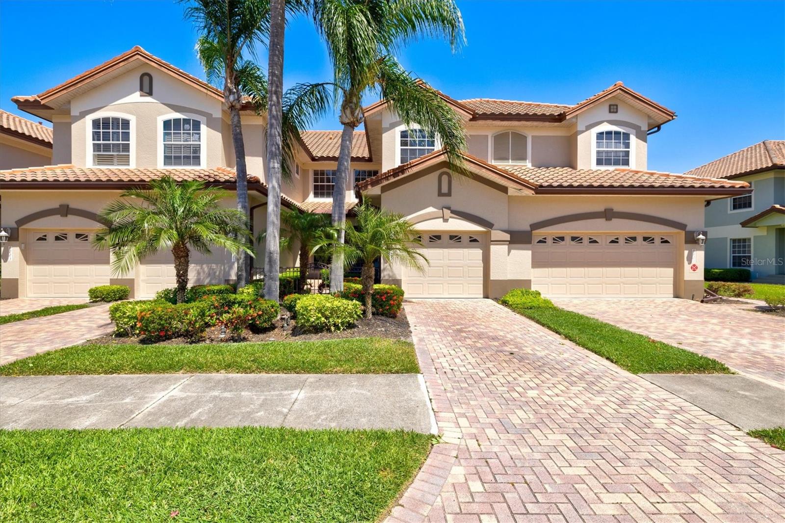 Welcome to Miramar at Lakewood Ranch Country Club, where maintenance-free living meets an exceptional Gulf Coast lifestyle. This GROUND-FLOOR, END UNIT at 8227 Miramar Way offers 2 bedrooms plus a den, 2 bathrooms, and 1,626 square feet of thoughtfully designed living space, enhanced by abundant natural light.

From the moment you arrive, the courtyard entry and mature tropical landscaping create a warm and inviting first impression, complemented by the timeless beauty of the barrel tile roof. Inside, elegant features include crown molding throughout the main living area, arched doorways, and upgraded ceiling fans with integrated lighting and speakers.

The kitchen has been enhanced with additional cabinetry, while recent updates provide peace of mind, including five HURRICANE IMPACT WINDOWS installed in 2022, HVAC (2021), tankless water heater, Culligan water softener (2020), microwave (2023), dishwasher (2024), and a washer/dryer combo (2026). The primary suite offers a relaxing retreat with dual sinks, a garden tub, and a separate shower with built-in bench.

Miramar residents enjoy low HOA fees and resort-style amenities, including a heated pool and spa, fitness center, and a scenic dock with gazebo—perfect for sunset views and bird watching.

This gated community is conveniently located near Lakewood Ranch Main Street and Waterside, UTC shopping and dining, I-75, and an abundance of public and private golf courses, this home is also just 30–45 minutes from the world-renowned beaches of Siesta Key, Longboat Key, and Anna Maria Island. Whether you’re seeking a primary residence, seasonal retreat, or investment opportunity, this home offers the perfect blend of comfort, convenience, and lifestyle. 3D Matterport tour available.