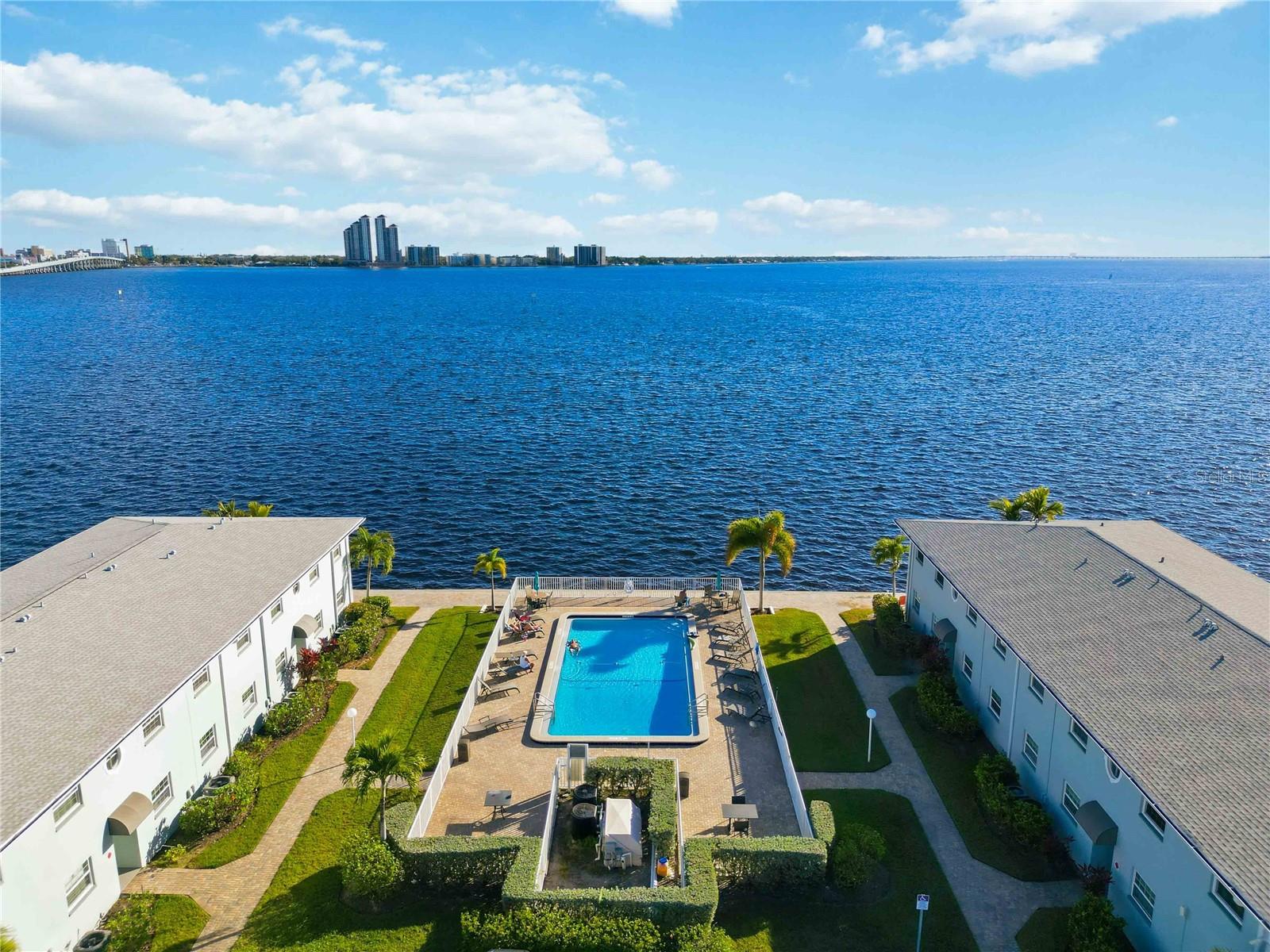 Waterfront views at an exceptional value await at 3326 N Key Drive, Unit D7, a beautifully updated and fully furnished two-bedroom condominium located in the highly desirable Palms at Waters Edge community on the Caloosahatchee River in North Fort Myers. Offered turnkey furnished, this residence captures sweeping riverfront vistas and delivers true Florida waterfront living with peace of mind, featuring a new roof, newer impact-rated storm windows throughout, luxury waterproof plank flooring, a new water heater, an updated electrical panel, and a newer air-conditioning system. The interior is bright and inviting, designed for effortless living and entertaining, while the furnished setup allows you to move in immediately or begin enjoying seasonal living from day one. Palms at Waters Edge is a meticulously maintained riverfront community known as one of Southwest Florida’s best-kept secrets, offering a resort-style pool overlooking downtown, a scenic captain’s walk that runs directly along the river, picnic areas with grills, and lush tropical landscaping throughout the property. The location is unmatched, just a short walk to Marina Town with its waterfront restaurants and marina access, or hop on the convenient trolley for a quick ride into historic downtown Fort Myers where shopping, dining, live entertainment, and cultural events abound. Nearby amenities include marinas along the Caloosahatchee for boating and fishing, popular dog parks such as North Fort Myers Community Park, and easy access to everyday conveniences including grocery stores, healthcare, and schools serving the North Fort Myers area. Enjoy proximity to world-renowned beaches like Fort Myers Beach and Sanibel Island, along with quick access to major roadways including US-41 and I-75, making travel to Cape Coral, Punta Gorda, and Southwest Florida International Airport seamless. Public transportation options, including trolley service and bus routes, add to the ease of living in this centrally located waterfront community. Whether you are seeking a primary residence, seasonal retreat, or investment opportunity, this move-in-ready waterfront condominium offers lifestyle, location, and value rarely found at this price point. Schedule your private showing today.