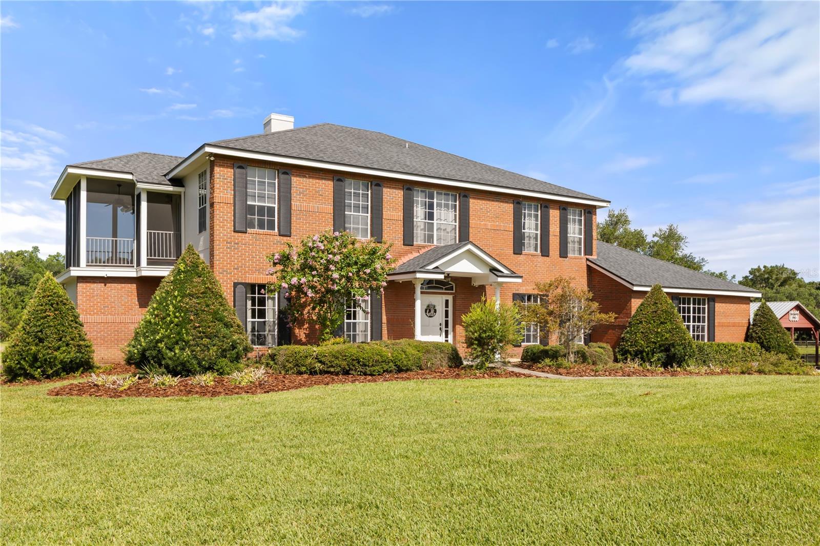 Within an extraordinary 143-acre private estate surrounded by more than 50,000 acres of state forest, this exceptional property offers a rare opportunity to own a Florida sanctuary where luxury living, equestrian pursuits and breathtaking natural beauty exist in harmony. The home features five bedrooms, three full baths and two half baths, plus more than 4,200 square feet of living space, including a safe room with reinforced concrete walls as well as a safe for storing valuables. A welcoming fireplace anchors the main living area, while the expansive three-car garage includes a Tesla universal charging station. Designed for everyday living and entertaining, the home serves as the ideal centerpiece for this remarkable estate. The land itself is nothing short of spectacular. More than 30 acres have been cleared and improved, providing ample space for horses, livestock, recreation or future expansion. Approximately 80 acres extend south of the residence and include a secluded campsite tucked among the trees, creating the ideal setting for weekend gatherings, hunting retreats, or simply enjoying the peace and quiet of nature. An additional 22 acres stretch in front of the home, creating an impressive approach and enhancing privacy. Horse enthusiasts will appreciate the property's extensive outdoor facilities, including a barn with two air-conditioned tack rooms, two wash racks, and a bath with water and septic service. The grounds also feature an Olympic-size dressage arena, a lighted horse arena and a round pen, providing ample space for training, riding, exercising horses, or simply enjoying an equestrian lifestyle. An extensive network of over five miles of trails winds throughout the property, ideal for horseback riding, hiking, trail running, ATV use or simply enjoying the diverse landscape. Three ponds provide scenic views and attract abundant wildlife. Beyond the cleared pastures and equestrian amenities lies a landscape rich in natural Florida beauty. Mature woodlands and abundant wildlife create a setting that feels worlds away from the demands of everyday life. Deer, turkey, bears and many bird species are frequent visitors, offering a front-row seat to Florida's natural environment. Surrounded by state forest, the property offers a rare combination of privacy, natural beauty and outdoor recreation that is increasingly difficult to find in today's market. Yet while the estate feels remarkably remote, it remains convenient for access to Lake Mary, Winter Park, downtown Orlando, major airports and Florida's renowned east coast beaches, offering the best of both worlds, seclusion without isolation. Additional improvements include a dog run, well house, storage building, and a comprehensive backup power system featuring a 550-gallon diesel fuel tank and a generator capable of powering the entire home, well, and air-conditioning systems, providing peace of mind during any weather event. Whether you're seeking a private equestrian estate, working ranch, recreational retreat, family compound or investment in one of Florida's increasingly scarce large-acreage properties, this extraordinary estate offers an unmatched combination of privacy, functionality and natural beauty. With direct access to miles of trails, abundant wildlife and the added benefit of being surrounded by more than 50,000 acres of protected state forest, this is a property that can be enjoyed for generations to come.