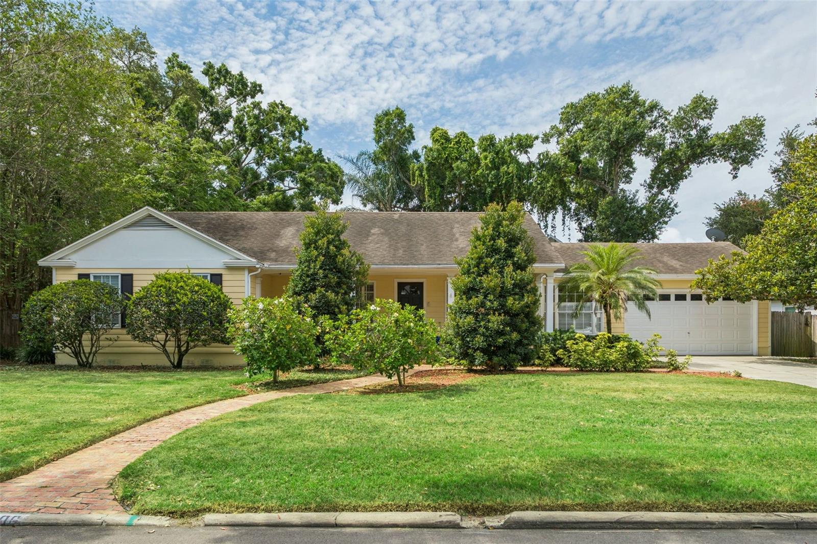This charming single-story pool home is situated on a spacious 100' x 100' lot in the quiet South Tampa neighborhood of Virginia Park/Maryland Manor. A brick walkway and expansive six-car driveway lead to a welcoming covered front porch, creating exceptional curb appeal.  Inside, the front door opens to a formal living room and a separate formal dining room featuring a bay window and elegant picture-frame molding. The dining room flows seamlessly into the well-appointed kitchen, complete with white cabinetry, granite countertops, a stone subway tile backsplash, and stainless steel appliances.  Beyond the kitchen, the large family room serves as the heart of the home, featuring a wood-burning fireplace and dual French doors with sidelights that open to the backyard and pool area, providing an abundance of natural light and effortless indoor-outdoor living.  The primary suite offers chair-rail molding and a spacious walk-in closet with a custom organization system, accessible from both the bedroom and the en-suite bath. The primary bathroom features an extended dual-sink vanity, a large walk-in shower with a built-in bench, and a private water closet. Conveniently, the bath also provides direct access to the backyard, making it an ideal pool bath.  Two additional bedrooms share a hall bathroom with a tub/shower combination, while the fourth bedroom is privately located off the family room and includes its own en-suite bathroom with a walk-in shower—perfect for guests or multigenerational living. A separate office nook with sliding glass doors overlooking the pool area provides a comfortable space to work from home.  The spacious backyard is designed for both relaxation and recreation. It features a brick patio extending from the family room, a secondary wood deck off the office, a sparkling pool, and a spacious turfed play area with a playset.  Additional highlights include solid oak flooring throughout the formal living and dining rooms, family room, hallway, and one guest bedroom; crown molding; plantation shutters; coat and linen closets; and a garage equipped with built-in cabinetry, a storage loft, and a utility sink.  A/C’s 2017,2018,2020; pool heater 2016; 2020 water heater; hall bath 2019.  Located within one of South Tampa’s most sought-after school districts, Virginia Park offers convenient access to shopping, dining, and everyday amenities. The home is also just minutes from Hyde Park Village, Bayshore Boulevard, downtown Tampa, Tampa International Airport, and the major interstates and bridges providing easy access to St. Petersburg.