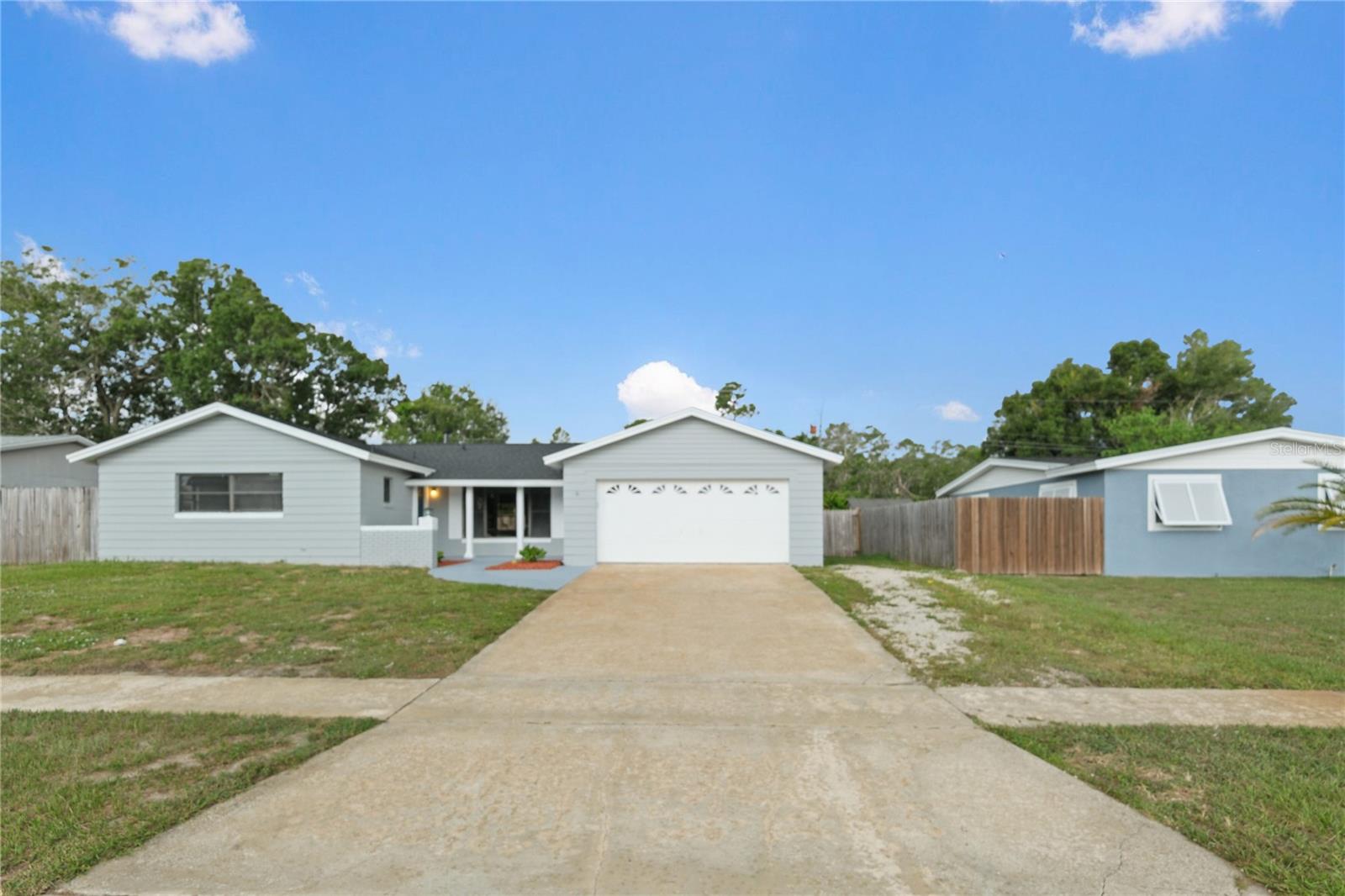 Welcome to this beautiful 4 bedroom 2 bath home that has a newly painted exterior, fenced in backyard with screened in patio for entertaining, and a covered front porch for you to relax and unwind. Walk in and discover a fully renovated home that features an open concept, freshly painted interior, new Luxury Vinyl Plank flooring throughout the main and wet areas, new carpet in the bedrooms, new lighting and doors throughout the home, spacious living room, and a separate dining space with chandelier. You’ll enjoy cooking in your Beautifully upgraded kitchen that boasts granite countertops with granite island, new cabinetry, new Stainless Steel slide in range, a custom vent hood that’s a showstopper, a pantry and an eating area. Your bathrooms feature new vanities, gorgeous granite countertops, new mirrors and lighting, and have tiled walls. Your garage has a new opener, new lighting, has been newly painted, has a new electrical panel and wiring, newer roof, 2022 AC, and a 2023 water heater. Enjoy being close to the ocean, parks, restaurants, and the I-95 Hwy. Book a private showing and come see this home today.