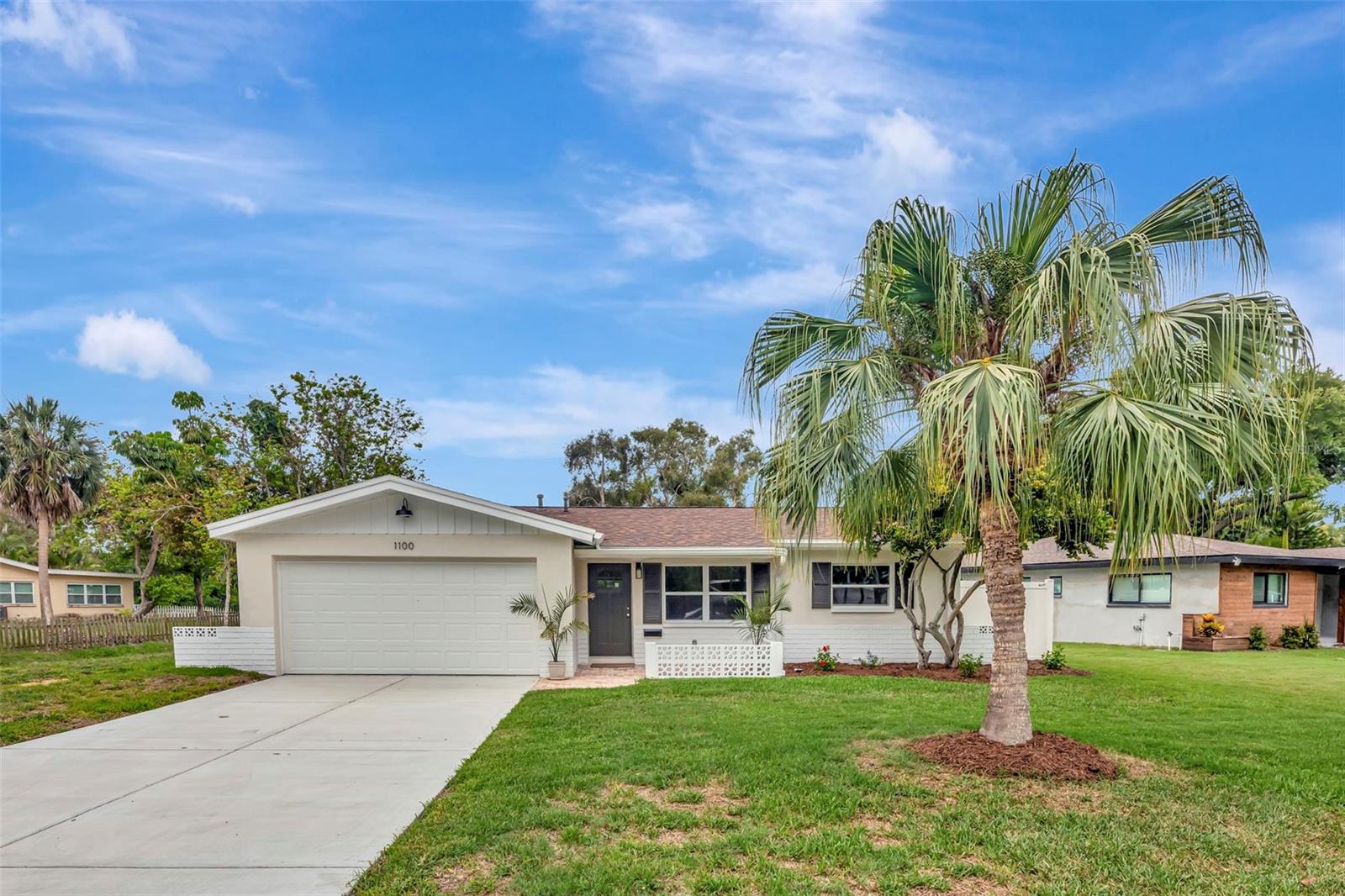 Virtually Staged. Well appointed WATERFRONT, block construction home offering 1,200+ square feet of comfortable living space in one of South St. Pete's established neighborhoods on an oversized lot with serene lake views. This home has been meticulously maintained and upgraded with a newer roof (2021), upgraded 200-amp electrical panel, new air conditioning system (with warranty), newer water heater, and newer garage door with remotes. Fresh flooring flows throughout, complemented by all-new top-of-the-line appliances. The updated kitchen showcases newer cabinetry, granite countertops, and a stainless steel sink and faucet. Both bathrooms have been elevated with new high-end vanities, Kohler toilets, and premium fixtures and faucets throughout. A new sliding glass door opens to an expansive backyard with plenty of room for a future pool. Entertain or unwind on the spacious paver screened porch overlooking the lake, or enjoy the charming paver front porch. Stylish, modern lighting fixtures and ceiling fans add a polished touch throughout the home. The home has been freshly stuccoed and painted for a refreshed, modern exterior, with new gutters and fresh landscaping completing the picture. A two-car garage provides added convenience and storage. Located in Saint Petersburg, you'll enjoy easy access to world-class beaches, vibrant dining and arts districts, top-rated parks, and the energy of downtown St. Pete which is all just minutes away. With no HOA, you'll have the freedom to make this home truly your own. This is a must-see property!