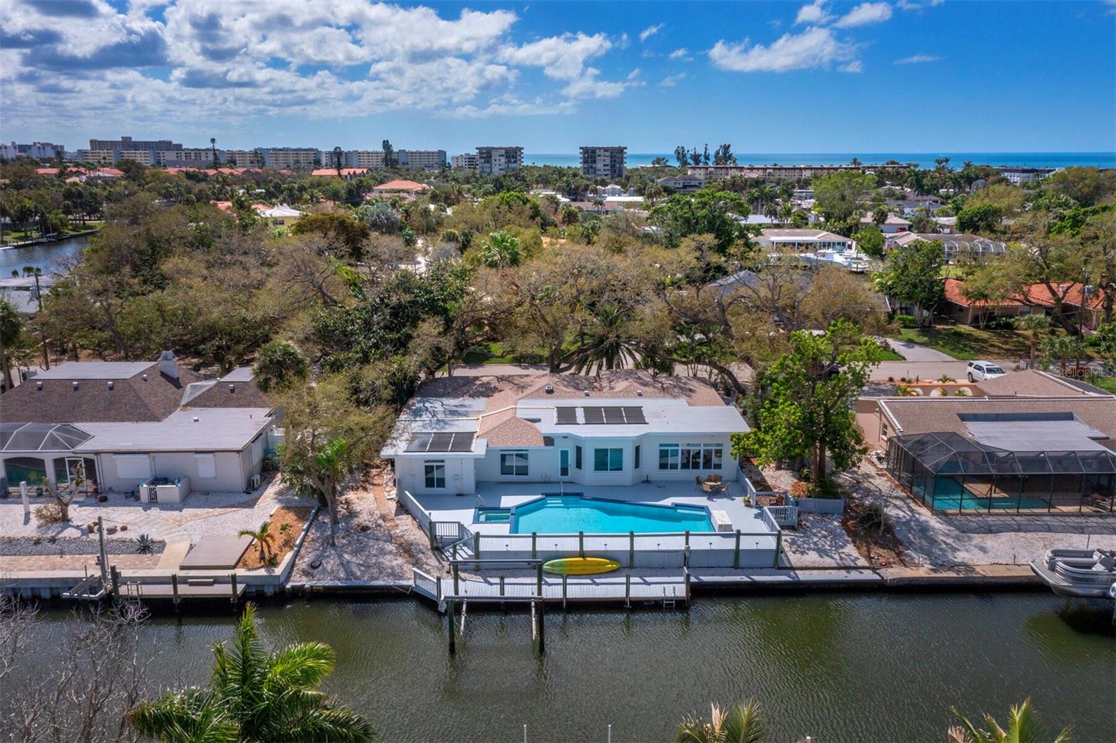 New low price and potential seller financing! Deep boating water on the Grand Canal and Siesta Key’s world-famous beaches just minutes away, experience the best of island living. This beautifully renovated three-bedroom, three-bath waterfront residence offers a peaceful island retreat with nearly 2,900 square feet of living space plus a private office, ideal for everyday living and entertaining. On a quiet cul-de-sac in the desirable Siesta Isles neighborhood, the property enjoys approximately 99 feet of canal frontage with deep boating water and convenient access to Sarasota Bay and the Gulf of Mexico via a single bridge. The dock, rebuilt in 2024, is ready for boating, paddleboarding, kayaking, fishing and enjoying Sarasota’s exceptional waterways. Recently completed renovations have transformed the home into a fresh, move-in-ready coastal residence. Bright and welcoming interiors feature new finishes and thoughtfully selected materials. The open living spaces are designed to capture the beauty of the waterfront setting, creating a natural flow for relaxed living and entertaining. The newly redesigned kitchen features classic shaker-style cabinetry, quartz countertops and new appliances, creating a functional and stylish centerpiece for the home. Impact-rated windows and doors, a newer roof (2024), and a freshly painted exterior provide beauty and peace of mind. The spacious primary suite enjoys tranquil canal views through French doors and includes a private sitting room, creating a comfortable retreat in the home. The large primary bath provides generous space and is designed for relaxation and convenience. Outdoor living is equally inviting. The expansive pool terrace with oversized pool and spa overlooks the canal, offering a private setting for relaxing or gathering with friends and family. Begin your day with coffee on the pool deck while enjoying brilliant sunrises and end the evening with Siesta Key’s vibrant sunsets just minutes away at nearby Siesta Beach. Ideally near Siesta Key’s renowned quartz-sand beaches, the boutiques and dining of Siesta Village, and cultural amenities of downtown Sarasota, including the Ringling Museum and Marie Selby Botanical Gardens, this location combines island tranquility with convenient access to the area’s best attractions. Offering the rare combination of a beautifully renovated waterfront home, deep boating water, and a peaceful Siesta Key setting, this exceptional property captures the essence of Sarasota’s island lifestyle. Possible seller financing for qualified buyers.