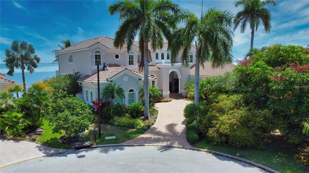 Longboat Key’s Country Club Shores is rolling out the dockside red carpet for you at your new Mediterranean-inspired oasis featuring 247' +/- of open Sarasota Bay and canal front views. Meticulously maintained since it was built in 2006, this extraordinary home with six sprawling bedrooms and 6.5 bathrooms is an intricately-detailed masterpiece from the tiled floors to the ornate ceilings. Whether you crave adventure or seek serenity, you will find all your hearts’ desires right out your back door, where you can cast your gaze or set sail onto The Gulf of Mexico, Sarasota Bay, and the Intercoastal Waterway. With this unique “tip” waterfront lot, you will enjoy constant views of the water set against our world-class sunsets. You will find unmatched relief in the way the entire property has been designed intuitively with waterfront living and entertainment in mind, from the impressive landscaping to the flow and layout of the floor plan. If you’re in search of the perfect place to hide away, reconnect with what matters most, and start a new chapter, this is the property that you need to tour next. Book your showing today to uncover the limitless possibilities that won’t stay a secret for much longer at 596 Outrigger Lane.