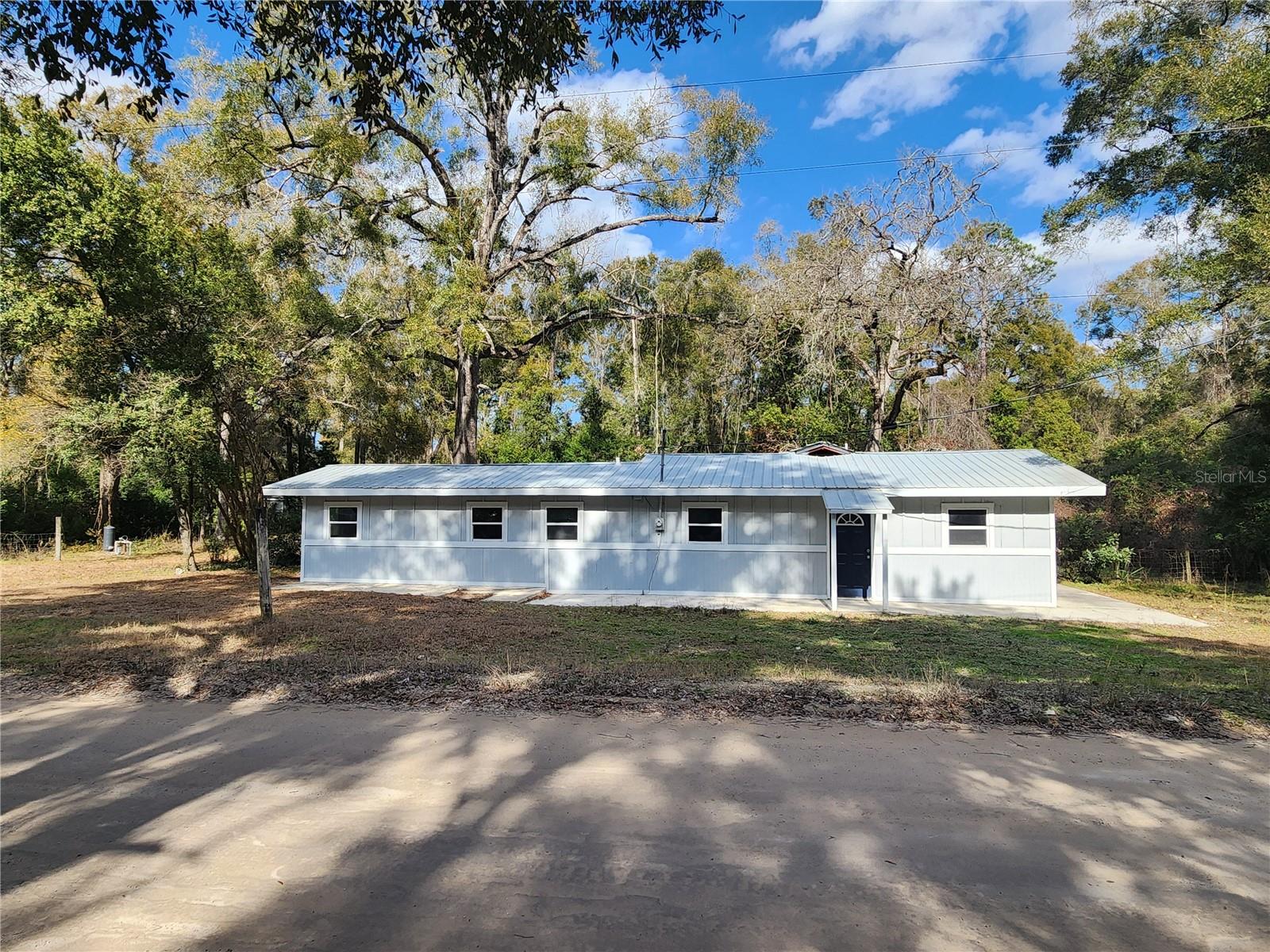 One or more photo(s) has been virtually staged. Come see this freshly renovated home that offers space and privacy only a short drive from Fanning Springs and the Suwannee River. The unique layout allows for flexibility in how you use the home. There are three bedrooms, two full bathrooms, living room, dining room and kitchen in the main area. The large flex room has its own access door from outside and a closet so it can function as a second living area or an additional bedroom as needed. Between the flex room and kitchen is a spacious laundry room which provides storage or kitchen pantry area. Over a third of an acre lot means there is room to play outside, plant a garden or add a coop! The hard part is done, now it just needs your vision to make this home your own!