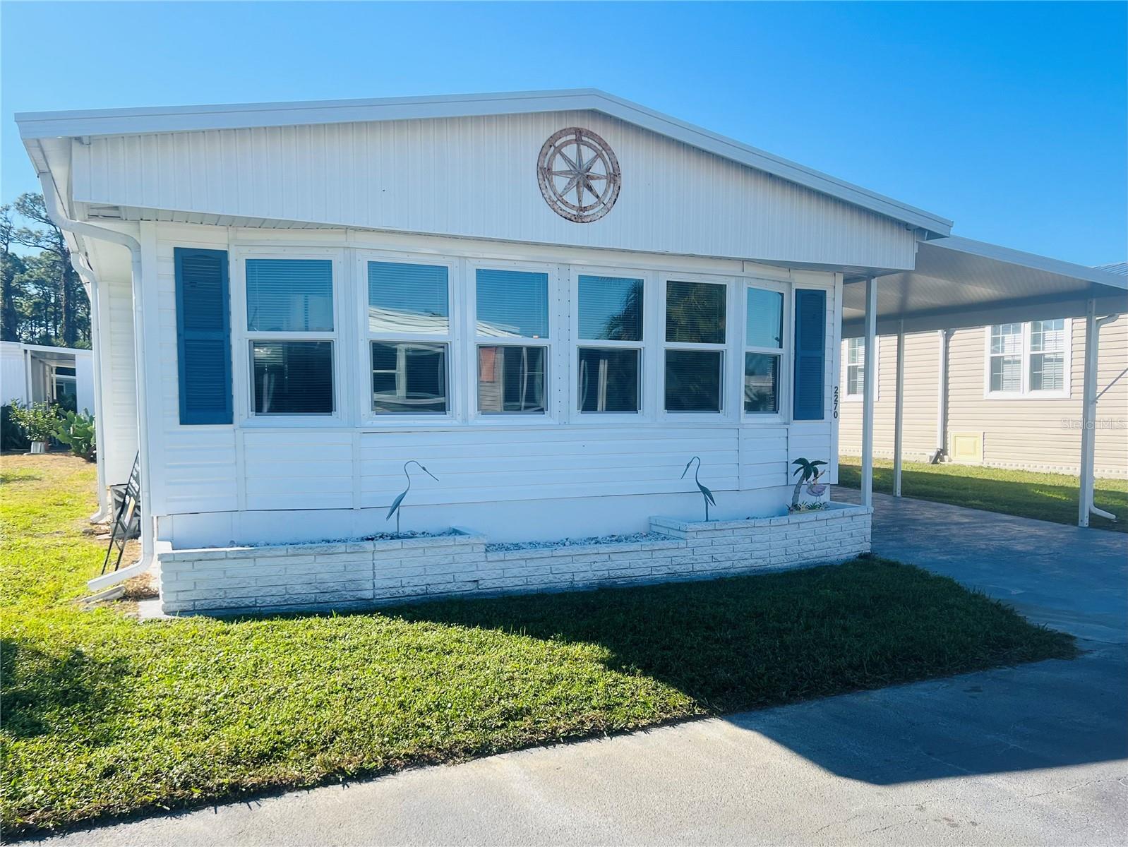 Fabulous new price for this beautifully decorated, nautical-style, double-wide manufactured home is located in the desirable Venetian Park Estates. The property features two bedrooms, two bathrooms, and a charming four-season renovated lanai. The home is fully furnished down to the last detail, this turnkey-home is perfect for Florida living. Venetian Park Estates is an active, over-55 community offering a heated pool, spa, shuffleboard, and various community events, including Bingo, Trivia, Game Night, Poker, and holiday celebrations. Conveniently situated near shopping, the property is only five miles from the renowned Siesta Key Beach. Must see to appreciate!!