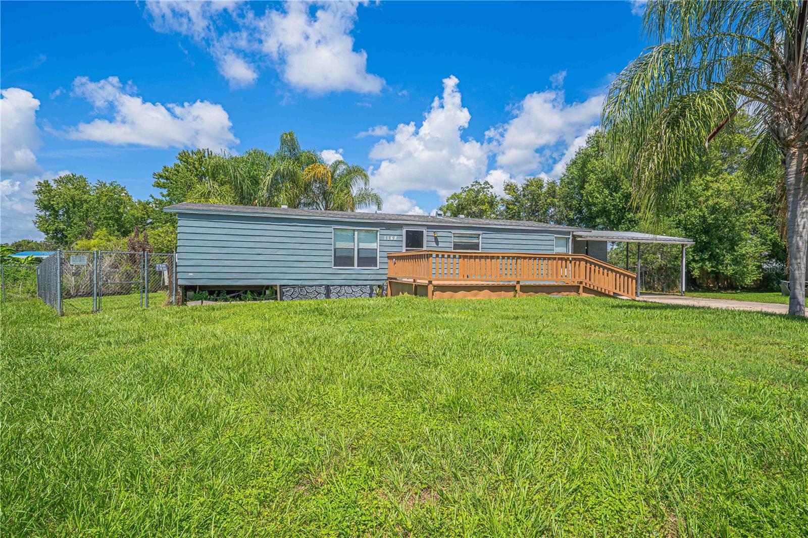 What if every day felt like a vacation? Tucked away at the end of a peaceful cul-de-sac, this hidden gem is more than a home—it's your own private tropical retreat. From the moment you arrive, you'll notice the wide, wheelchair-accessible walkway welcoming you inside. Step through the front door to an airy, open-concept living space that's perfect for entertaining or simply enjoying life's everyday moments. The beautifully updated kitchen features newer wood cabinetry, a brand-new dishwasher, and brand-new microwave, making it as functional as it is inviting. The thoughtfully designed split-bedroom floor plan gives the spacious primary suite the privacy it deserves, complete with a large walk-in closet. But the real magic happens outside...Open the double French doors and step into your own backyard paradise. Relax on the oversized screened lanai while overlooking the sparkling screened-in pool, surrounded by swaying palm trees and a lush backyard that feels like a Florida resort. Whether you're hosting family barbecues, enjoying a quiet morning coffee, or cooling off on a sunny  afternoon, this backyard was made for making memories. Need extra space? The enclosed backyard shed is perfect for a workshop, hobby room, or additional storage. An extra-long driveway accommodates up to six vehicles, while the covered carport offers convenient side-entry access. And the location? Just minutes from Orlando's world-famous theme parks, Orlando International Airport, premier shopping, dining, and entertainment. This home is a perfect blend of privacy, space, convenience, and resort-style living