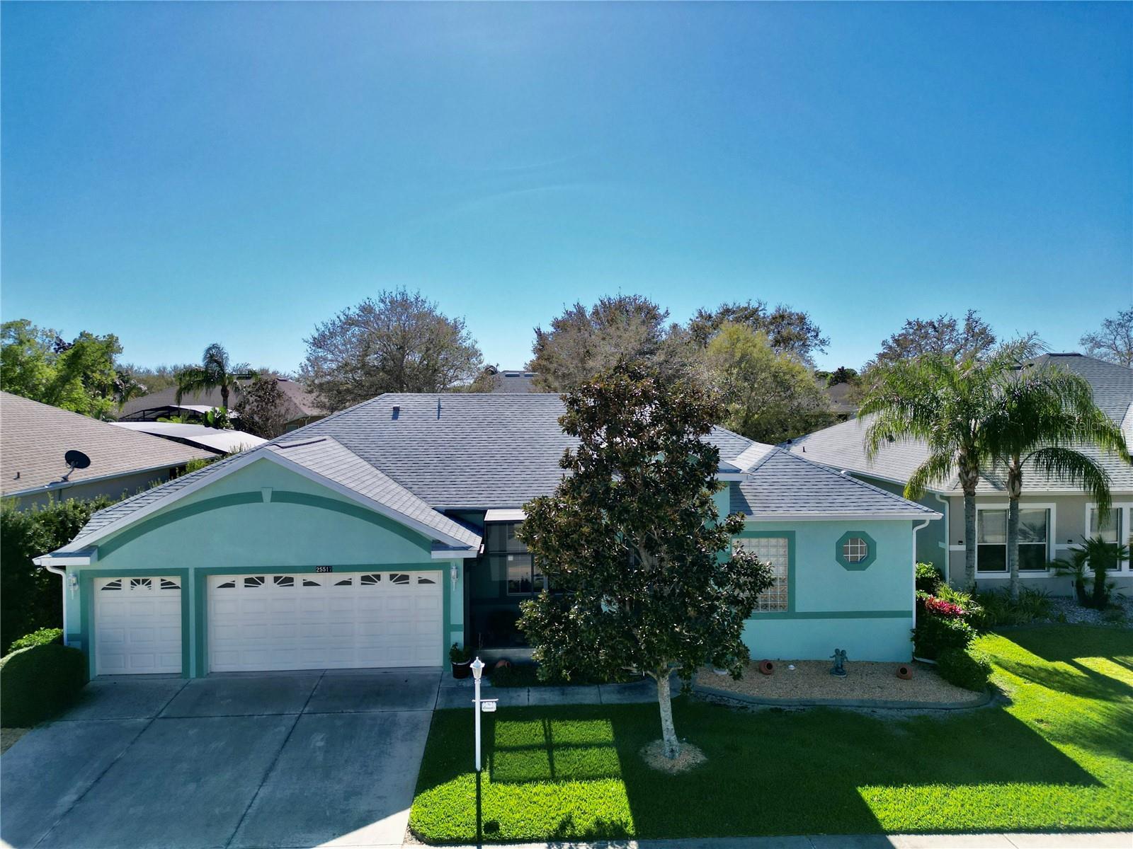 NOW OFFERING A HOME WARRANTY UP TO $500.00 AT CLOSING. Discover the perfect blend of comfort and elegance in this meticulously maintained Bird of Paradise home, offering 3 bedrooms, 2 baths, and a dedicated office with a stylish workspace. The third bedroom even features a built-in desk for added versatility. An extended, enclosed lanai (added in 2008) creates a stunning Florida room, while the oversized 2.5-car garage provides ample space for vehicles and a workshop and/or golf cart. The kitchen is a chef’s delight, boasting recessed lighting, 42” maple cabinets with under-cabinet lighting, upgraded stainless steel appliances, Corian countertops, a new garbage disposal, a spacious breakfast bar, and a cozy dining area. The inviting family room features custom built-in cabinetry and surround sound, while the utility room offers generous storage, a utility sink, and a high-end washer and dryer. Additional highlights include double-pane windows with 3M hurricane protection, tailored foam insulation, and R30 insulation over the lanai and garage. Recent updates include New durable heavy domestic Finfloor lifetime warranty laminate flooring throughout the home (2025), new Goodman HVAC system (2025), a new roof (2022), front entry screen enclosure (2015), under cabinet lighting in kitchen, office, and utility room, and LED lighting throughout. The block/stucco exterior has been freshly painted ensuring excellent curb appeal. Nestled in the gated, beautifully landscaped 55+ community of The Plantation at Leesburg, this home grants access to resort-style amenities, including: tennis, pickleball, shuffleboard, bocce, horseshoes, three pools with hot tubs, three clubhouses, two golf courses, a driving range, a putting green, exercise rooms, a sauna, an outdoor kitchen pavilion, lots of social activities, entertainment, and clubs Plus, enjoy the convenience of a restaurant, diner, medical clinic, cigar lounge, nail salon, thrift shop, place of worship, and you can even renew your driver's license—all within a short golf cart ride! Conveniently located in central Florida, Lake County is home to many lakes including the chain of lakes plus you are approximately 1 1/2  hours from either coast, less than an hour from the attractions, and all that central Florida has to offer.  Experience the best of Florida living—schedule your showing today!