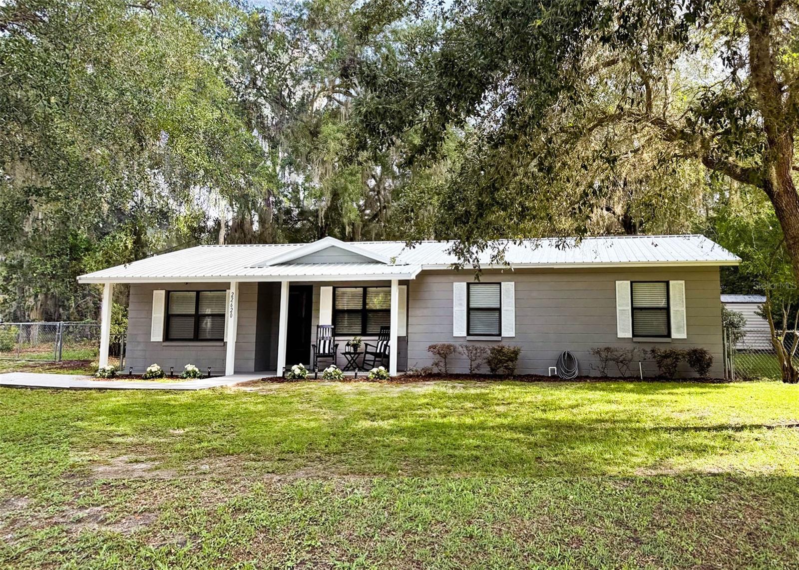 Centrally located in the heart of Hawthorne, this updated 3-bedroom, 2-bath home is truly move-in ready! Recent improvements include a new roof, fresh interior paint, new carpet, and a new water heater--giving you peace of mind from day one. There is a 13 ft x 27 ft bonus room that could be a den, home office or playroom.  The spacious laundry room offers added storage with new flooring and shelving, plus a generator hook-up. Electrical utilities are provided by FPL and water and sewer are provided by the City of Hawthorne. Enjoy your morning coffee on the inviting front porch or unwind in the screened back porch overlooking the fully fenced backyard--perfect for pets, play, or entertaining. The metal shed out back holds extra storage. Ideally situated just minutes from Gainesville, Palatka, and Ocala, this home offers small-town charm with easy access to everything you need. Don't miss your chance to make this one yours!