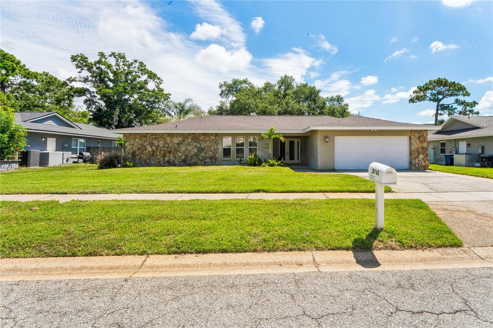 Here's your opportunity for a great buy in the desirable Countryside area.  Introducing a 4 bed, 3 bath pool home on a nicely manicured and fully fenced in lot.  As you enter through the double entry doors, you are welcomed by an abundance of natural light and sliders opening up to the screened Lanai for that indoor/outdoor connection.  Your eye is immediately drawn to the expansive patio and sparkling pool, making this 2538 SF home feel even larger.  The INTERIOR of the home as well as the pool deck have been FRESHLY PAINTED in June (2026), with new carpet in two bedrooms, and the rest of home is primarily tile with wood in the front living room.  Some of the highlights of this fantastic home:  Permitted ROOF (2017), Permitted 4 TON A/C system (2018), and Permitted WHOLE HOME GENERATOR with surge protection and transfer (2020).  And the list continues ...TANKLESS WATER HEATER (2019), WATER SOFTENER (2021), and VINYL FENCE (2017). This is not a fully remodeled home priced for top dollar. The Seller has priced this home to move, allowing the buyer to purchase BELOW MARKET VALUE so they can refresh and personalize for their own taste. You have plenty of room for improvements without pricing yourself out of the market. This is for the savvy buyer who wants to renovate and build equity in a premier location. There is a plethora of cabinetry and storage in the enormous kitchen. A full laundry room with more storage is conveniently tucked away between the kitchen and garage. The primary suite offers direct lanai and pool/ spa access and a spacious ensuite corner bath with two walk in closets.  There is another adjoining bedroom, lending this layout to be a true second bedroom or perhaps an ideal office, nursery, or home fitness center.  In this split floorpan home, we have bedrooms 3 and 4 on the opposite side of the house, with a second full bath nestled in between them. These bedrooms are both spacious and tiled.  At the back of the home is a third full bath with an entry door out to the pool.  And off of the kitchen is a very nice tiled family room or dining room.  There are pocket sliders that open up and allow for a wonderful flow of combining indoor and outdoor living.  Imagine entertaining your family and friends, hosting dinner, holiday, and birthday parties, pool parties, or just chilling alone and appreciating your new home in your private backyard.  Your new home is located in the high and dry "X" zone with no flood insurance required as Countryside is one of the highest elevation areas in Pinellas County.  Another bonus:  no HOA, yet the homes are pristine and the pride of ownership is evident!  From your front door, you have views across the street of the Chi Chi Rodriguez Golf Course, designed by Denis Griffiths. Additionally, there is the renowned Countryside Country Club with its Gary Player-designed golf courses only a few miles away. Sandy Ridge Dr. is conveniently located off of Landmark, half way between Curlew and 580.  There is easy access to shopping, restaurants, banking, medical facilities, golf venues, various parks and amazing Gulf beaches, sporting venues, the Pinellas Trail, and top-rated schools. There are two international airports within 30 minutes or so drive time.  Downtown Dunedin, Safety Harbor, and Tarpon Springs are all just a short distance away! Tampa and St. Pete are not too far either.   Allow yourself the opportunity to enjoy the Florida lifestyle and schedule your private showing today.