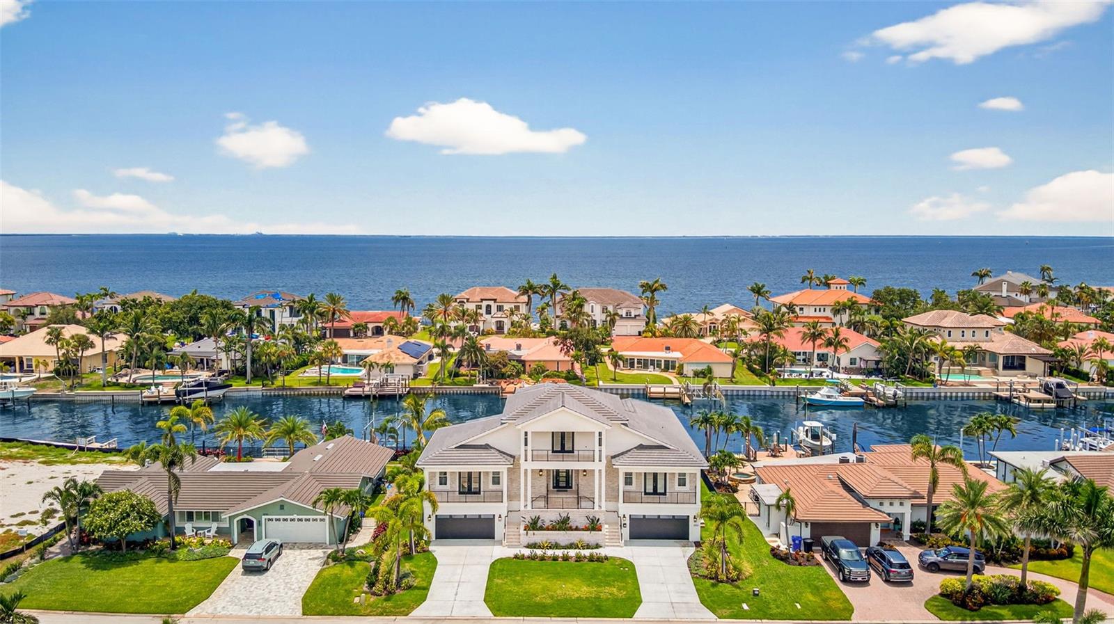 One or more photo(s) has been virtually staged. A dream opportunity can become your reality. Newly constructed custom home completed in 2025 extends an elevated experience to waterfront living. 4,317 under-roof living square footage encompassing 5 large bedrooms plus an office, 4.5 bathrooms, 8-car garage, and breezy balcony with views of Downtown Tampa. The moment you enter through the front door, you will be captivated by this coastal masterpiece with 10-foot ceilings, an abundance of natural lighting, beamed ceilings, and a kick back, relax, and stay awhile vibe. The custom design with front and rear French doors allows you to open the house up for a phenomenal crossbreeze or when entertaining and utilizing the indoor/outdoor living. The kitchen features a large island with a large prep sink, bar seating, a beverage station, a gas range, and overlooks the spacious living room with access to a large balcony overlooking the pool and spa area. Enjoy formal meals in the dining space with convenient access to the butler's pantry, which can be closed off and out of sight but contains storage, a second full-size dishwasher, and space for a large wine or full-size second refrigerator. The split floor plan extends 3 bedrooms and 2 bathrooms on one side of the house. Guest powder bathroom, private office, and a Jr primary suite are also on the main level. Jr primary suite overlooks the water and pool with balcony access. En-suite large bathroom with walk-in shower and walk-in closet. The second-level living is designed to work as needed. This space extends to a spectacular primary bedroom with a reading nook, breakfast/coffee bar, and an impressive en-suite bathroom. The second-level balcony is the perfect place to relax, enjoy an evening breeze, or watch the sunrise in the morning. Year-round fish in your backyard, and watch the dolphins or manatees play. Brand new beautiful pool with spa, substantial new raised seawall, and green space for kids or pets. The property can accommodate a very large deep vessel or dock. Canal offers protection and unobstructed direct access to Tampa Bay. Conveniently located with proximity to top-rated schools, shopping, and one mile from the upscale neighborhood market. Kayak or paddleboard from your backyard to Weedon Island Preserve. Access Downtown St Petersburg by boat, golf cart, or even a bike ride, only 4 miles away. 25 quick minutes to our world-famous Beaches, 2 major international airports, and Albert Whitted private airport. Venetian Isles is an exceptional deed-restricted neighborhood with an optional HOA.