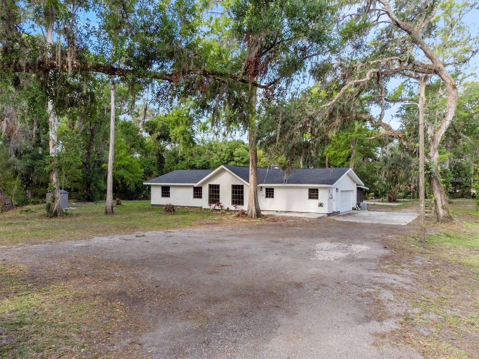 **Offering $5,000 seller concessions** Seller is motivated and ready to make a deal. Bring all reasonable offers. Welcome to 6005 Ike Smith Rd, a truly one-of-a-kind, fully renovated farmhouse-style home situated on 1.56 peaceful acres in beautiful Plant City. The tenant will be vacating the property by the beginning of March 2026, creating an excellent opportunity for owner occupants or investors planning ahead. This single-family residence blends high-end modern finishes with quiet country living and the flexibility of A-1 agricultural zoning, allowing for animals, gardening, or the addition of a workshop or barn. Inside, you will find a thoughtfully redesigned open-concept layout featuring brand-new kitchen cabinetry, modern fixtures, and completely renovated bathrooms with spa-inspired tile showers. Updates continue throughout the home with new doors including a stylish sliding glass door leading to the backyard, updated and framed windows for added charm and efficiency, new flooring throughout, a new water heater, and upgraded plumbing. Step outside to enjoy newly poured concrete porches at both the front and back, a screened-in rear lanai, and a tranquil river running along the back of the property, perfect for relaxing evenings or future outdoor projects. The expansive lot offers privacy, natural beauty, and no HOA restrictions, providing endless possibilities. Whether you are seeking a private homestead, peaceful retreat, or a move-in-ready property with modern upgrades, this home truly checks every box. Conveniently located just 10 minutes from I-4, offering easy access to Tampa, Lakeland, and Orlando. The property offers 1,695 square feet of fully updated living space with three spacious bedrooms and two bathrooms, all situated on a 1.56-acre lot with river access and A-1 zoning that allows for animals, barns, or gardening. Major systems have been upgraded including plumbing, water heater, flooring, doors, and windows, making this home truly move-in ready with premium finishes throughout. Seller is motivated and seeking a smooth, timely closing. Do not miss this opportunity. Call today to schedule your private showing.