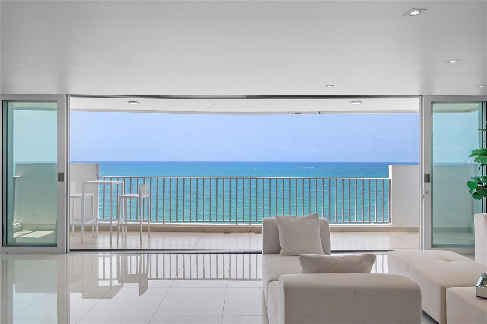 Where the Atlantic becomes your most extraordinary piece of art.

Perfectly positioned on the oceanfront, this exceptional residence has been completely reimagined with meticulous attention to detail, creating a home where architecture and the sea exist in perfect harmony. Floor-to-ceiling glass frames breathtaking panoramic views of the Atlantic, allowing the ever-changing horizon to become the centerpiece of every living space.

Designed for both sophisticated entertaining and effortless everyday living, the residence features 4 bedrooms, 3 bathrooms, an inviting family room, and 2 parking spaces. Expansive living and dining areas flow seamlessly onto a generous oceanfront terrace, blurring the lines between indoor comfort and outdoor beauty.

At the heart of the home is an exquisite Italian-designed Molteni&C and Dada kitchen, thoughtfully appointed with GE Monogram appliances. Clean architectural lines, bespoke finishes, custom lighting, and carefully curated details reflect a timeless aesthetic where form and function exist in perfect balance.

Nestled in the quieter oceanfront enclave of Condado, just off Ashford Avenue, this residence offers a rare sense of privacy and tranquility while remaining just moments from the neighborhood’s celebrated restaurants, boutique shopping, cafés, parks, schools, and beaches.

Residents enjoy exceptional amenities including 24-hour security, a full backup generator, water cistern, gym, and direct beach access, providing comfort, convenience, and peace of mind year-round.

More than a residence, this is a home where exceptional design quietly complements its greatest luxury—the endless Atlantic Ocean.