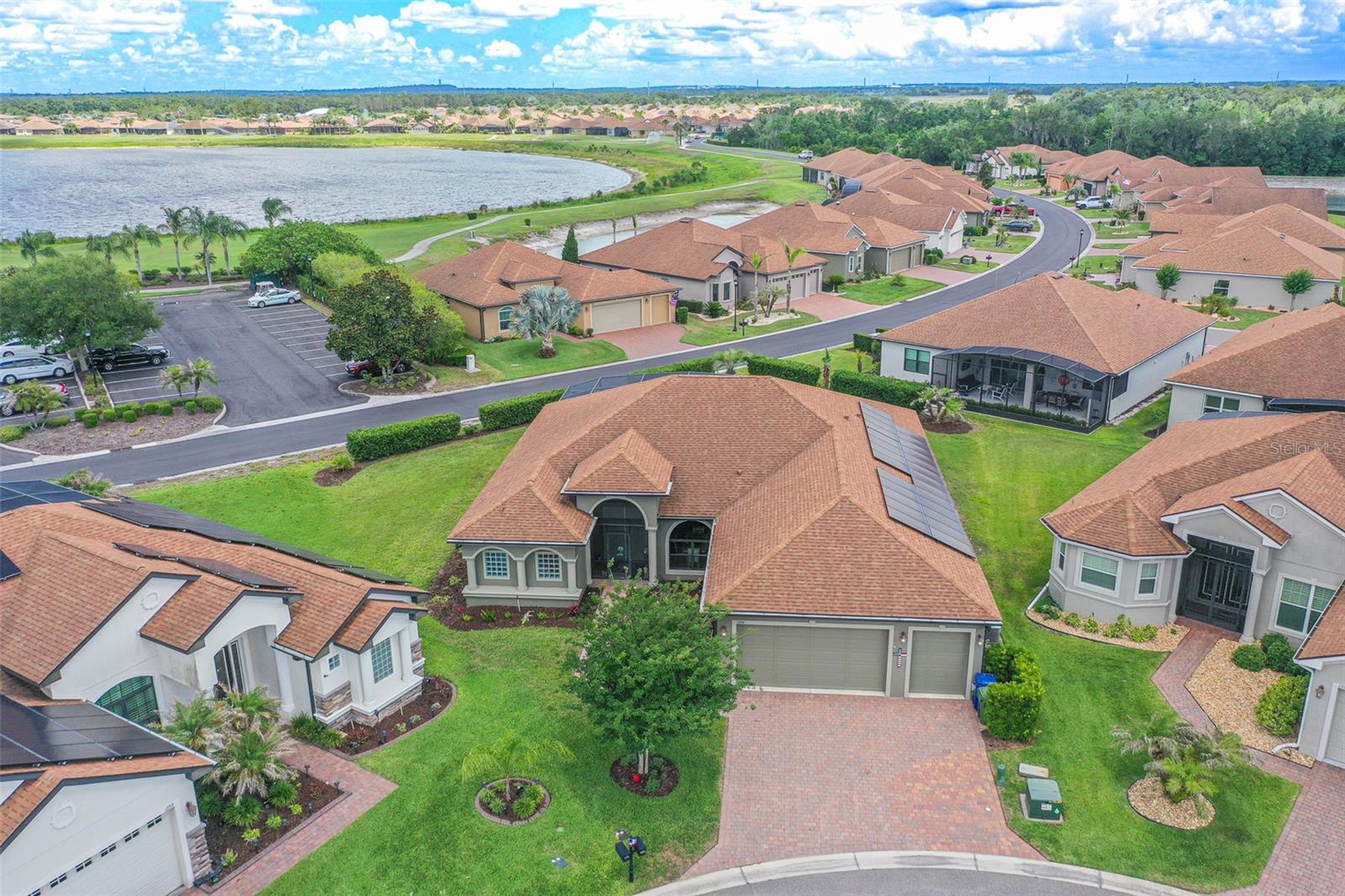 Experience resort-style living in the highly sought-after gated 55+ golf community of Lake Ashton, offering 24-hour security and an incredible amenity-rich lifestyle. Residents enjoy access to championship golf courses, multiple clubhouses, indoor and outdoor pools, fitness centers, tennis and pickleball courts, bowling, movie theater, restaurant and lounge areas, walking and biking paths, lake access, and a vibrant social atmosphere that makes Lake Ashton one of Central Florida’s premier active adult communities.

This beautifully upgraded Ashton floor plan offers approximately 2,606 square feet of living space with 3 bedrooms, 2 full bathrooms, a den, flex room, and a spacious 2-car plus golf cart garage with room for up to 2 golf carts. Inside, you’ll find soaring cathedral ceilings, tray ceiling accents, crown molding, recessed lighting, updated fixtures, and a seamless blend of laminate flooring and ceramic tile throughout. The gourmet kitchen features granite countertops, solid wood 42-inch cabinetry with crown molding, stainless steel appliances including a Bosch dishwasher and double convection ovens, along with abundant prep and storage space.

Designed for both comfort and efficiency, the home includes a FULLY PAID OFF SOLAR PANEL SYSTEM with transferable warranty, whole-house generator, enhanced landscaping, updated irrigation system, abundant storage, and negotiable furnishings for a potential move-in-ready opportunity. The spacious primary suite offers custom closets, soaking tub, oversized walk-in shower, and private sauna.

Enjoy Florida living year-round from the oversized screened lanai complete with remote-control privacy shades, outdoor kitchen with stainless steel grill, kegerator, wine fridge, barbecue area, and an impressive Veranda 10-person hybrid swim spa. The SELLER IS ALSO INCLUDING THE GOLF CART WITH THE SALE, making it even easier to enjoy everything the Lake Ashton lifestyle has to offer.