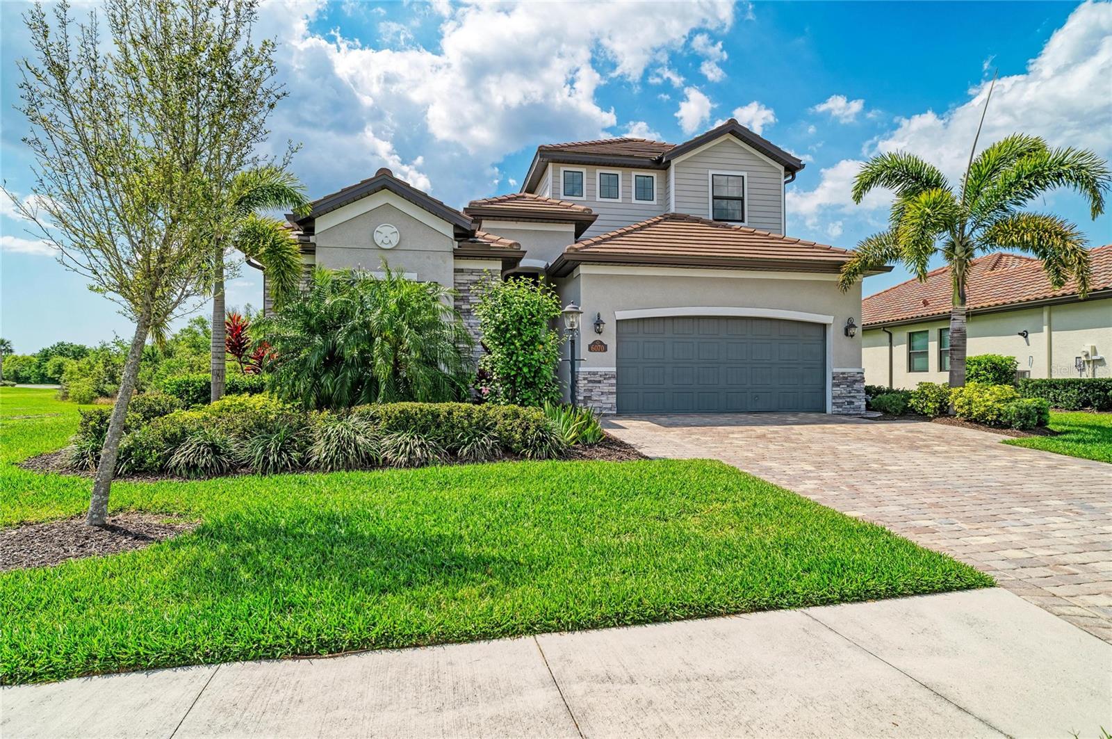 Experience championship golf and resort-style living from day one in this four-bedroom, four-bath residence within the gated community of Lakewood National Golf Club, one of Lakewood Ranch’s most sought-after bundled golf destinations. Designed for everyday living, seasonal use or multigenerational accommodations, the residence features a flexible floor plan with expansive living spaces filled with natural light. The second-level bonus room with a wet bar and full bath creates an ideal setting for a private guest retreat, media lounge or extended-stay living arrangement. Open-concept interiors transition seamlessly to the covered lanai, creating dedicated spaces for outdoor dining, entertaining and relaxation. The outdoor living area also offers ample space to add a private pool. Seller can provide conceptual renderings and a preliminary proposal for pool installation under $100,000. Residents enjoy access to seven community pools, including a resort-style pool with lap lanes. Lakewood National Golf Club is widely regarded as one of Southwest Florida’s premier bundled golf communities, anchored by 36 holes of championship golf designed by the Arnold Palmer Design Company. The community’s two award-winning courses, Commander and Piper, were thoughtfully designed to deliver a tournament-caliber experience while remaining approachable for players of all skill levels. Rolling fairways, strategic bunkering, expansive water features and preserved natural landscapes create a visually striking golf environment that has elevated Lakewood National into national recognition. The Commander course is home to the annual LECOM Suncoast Classic, a Korn Ferry Tour event that brings future PGA Tour professionals to the community each spring. In recognition of its premier facilities and tournament experience, Lakewood National Golf Club was named the 2025 Host Facility of the Year by the Korn Ferry Tour. The PGA Tour and Korn Ferry Tour have also secured a licensing agreement extending the tournament’s presence at the club through 2029. Located within Lakewood Ranch, one of the nation’s top-selling master-planned communities, residents are positioned near shopping, dining, medical facilities, cultural attractions and the Gulf Coast beaches, with convenient access to Sarasota and Bradenton. Furnishings are negotiable, presenting an opportunity for a streamlined move-in or seasonal transition. This residence combines flexible living, championship golf, established amenities and the ability to personalize outdoor living with a private pool, all within one of Southwest Florida’s premier golf communities.