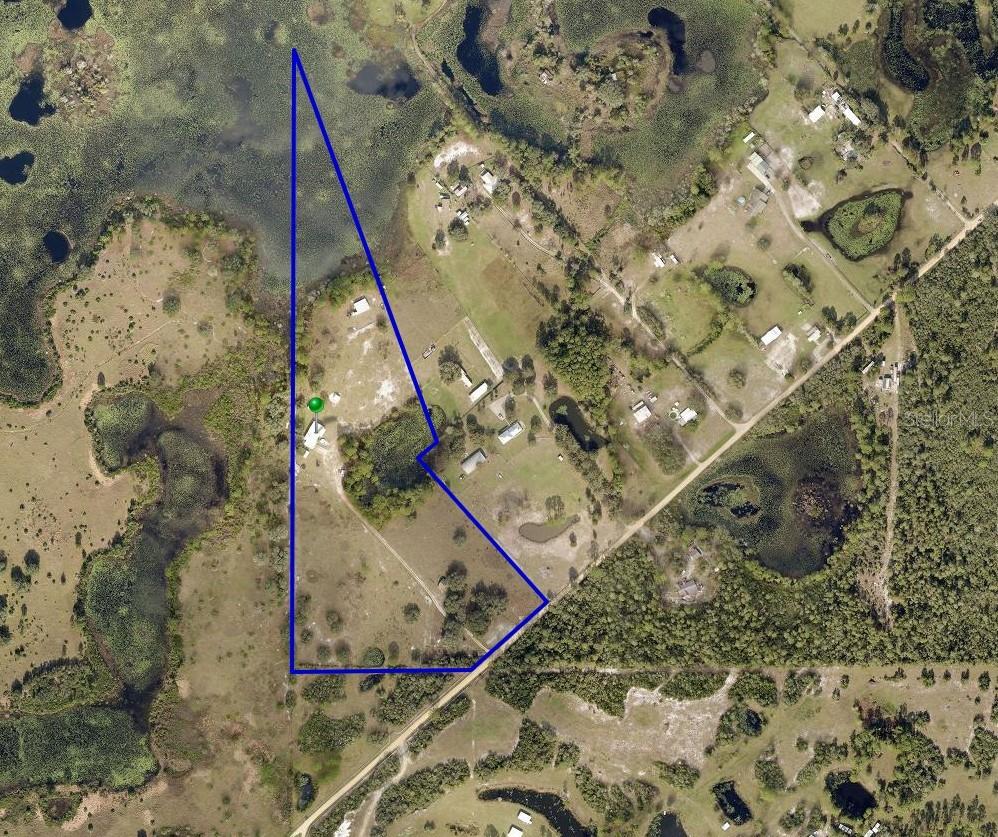 Experience the freedom of true Florida country living on this expansive 19.52-acre property tucked away on Fullerville Road in DeLand. Offering unmatched privacy, natural beauty, and agricultural zoning, this land is the perfect canvas for your dream homestead, farm, or recreational retreat.

One of the most exceptional features of this property is that it backs up directly to the Seminole State Forest, providing a rare level of seclusion, abundant wildlife, and uninterrupted natural views. With thousands of protected acres just beyond your boundary line, you’ll enjoy a serene backdrop and endless opportunities for outdoor exploration.

Zoned A (Agricultural), the land offers incredible flexibility bring your horses, livestock, gardens, or build a custom estate surrounded by nature. With over 850,000 sq ft of land, there is ample room for barns, workshops, trails, or multi-structure family living.

This property is already equipped with valuable improvements, including a 40x60 metal building with water and electricity available, a barn, three sheds, and two ponds that enhance both functionality and natural beauty. Majestic large oak trees provide shade and character throughout the acreage. The land also includes two electricity poles and two wells, one located at the front of the property and another at the rear where the home site is situated, offering exceptional utility access and development potential. Completely fenced in, miniature donkeys and chickens optional.

The property’s unique layout blends open land with natural Florida landscape, creating a peaceful environment ideal for those seeking space, privacy, and a deep connection to the outdoors. Despite its secluded feel, you’re still just minutes from historic downtown DeLand, local shops, dining, and major roadways.

Opportunities like this nearly 20 acres with agricultural zoning, extensive improvements, and direct access to the Seminole State Forest are incredibly rare.

Build your vision. Live your dream. Enjoy the unmatched tranquility of forest-backed acreage in beautiful DeLand.