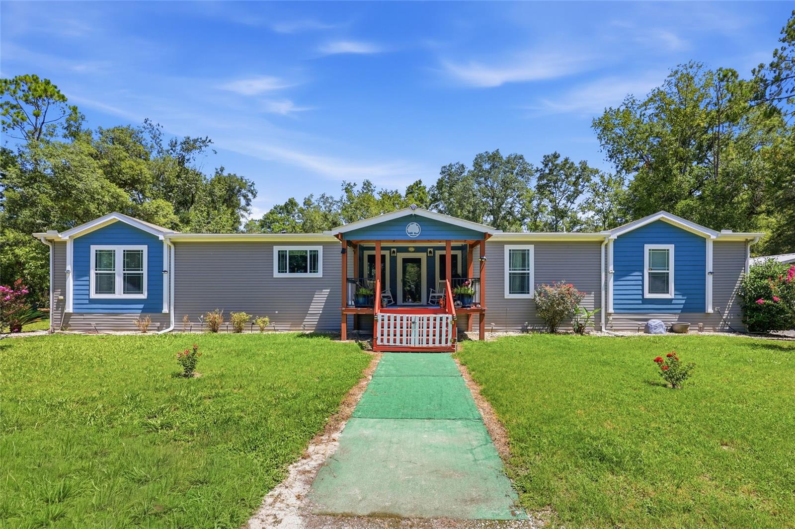 Welcome to your O’Brien oasis, a peaceful sanctuary offering the perfect blend of high-end country living and modern comfort. Situated on 4+ private, beautifully wooded acres under wide open North Florida skies, this immaculate 2021 upscale manufactured home is ready for its next steward.
Step inside to an expansive, sun-drenched open-concept layout defined by large windows, crown molding, and beautiful vinyl plank flooring throughout (with cozy carpet in the bedrooms). The heart of the home features a spacious living room centered around an inviting fireplace, flowing seamlessly into the kitchen. Chefs will love the massive island, pot filler over the stove, solid wood cabinetry, ample solid surface counter space, and integrated appliances. The split bedroom floor plan offers ultimate privacy for the primary suite, which includes a generous walk-in closet, a soaking tub, and an oversized shower. A huge mud/laundry room offers additional storage and effortless everyday utility, leading out to a beautiful back deck that could be converted into a Florida room. 

Outside, the property is a peaceful, open canvas waiting for your personal touch. It is the perfect setup for gardening, homesteading, or simply enjoying the tranquil rural surroundings without the restrictions of an HOA. Additional features include a detached 2-car carport, a workshop, and a private well.

Adventure and relaxation await just minutes from your front door. Located in a pristine area of Suwannee County, you are less than 20 minutes from three of North Florida’s absolute best freshwater springs and a convenient Suwannee River boat ramp. Whether you are looking for a full time modern homestead, a peaceful weekend retreat, or a strategic property investment, this O'Brien estate delivers unmatched space, peace, and value.