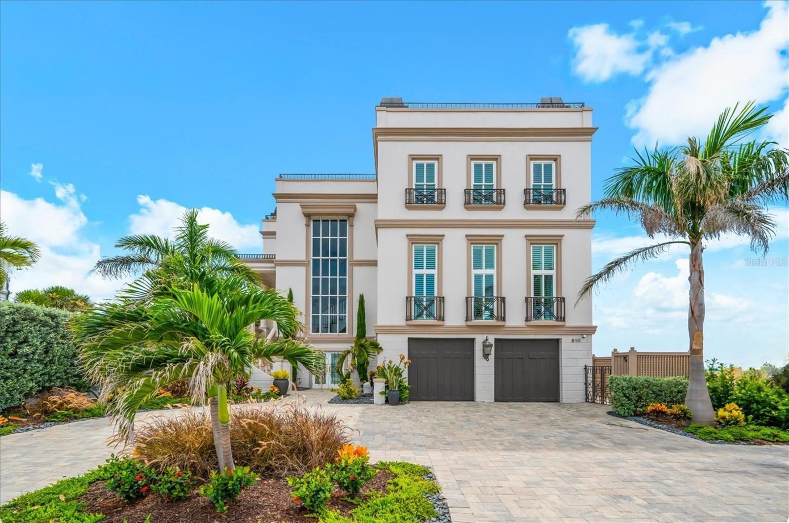 A rare offering along the iconic shores of Clearwater Beach, this exceptional Gulf-front estate embodies timeless coastal sophistication, remarkable craftsmanship, and an unparalleled waterfront lifestyle. Situated within the most coveted Mandalay neighborhood, this custom residence occupies an irreplaceable Gulf-front homesite with approximately 60 feet of direct beachfront, delivering unobstructed views across the Gulf of A and some of Florida's most spectacular sunsets.

Behind its impressive façade lies approximately 3,559 square feet of meticulously designed living space where elegant architecture meets modern luxury. Every room reflects thoughtful attention to detail, from soaring ceilings and extensive custom millwork to rich hardwood floors, natural stone finishes, multiple fireplaces, and expansive windows that showcase breathtaking Gulf vistas throughout the home.

Designed with both elegance and functionality in mind, the residence offers beautifully appointed formal and informal living spaces that effortlessly accommodate intimate gatherings as well as grand-scale entertaining. The gourmet kitchen features premium appliances, custom solid wood cabinetry, stone countertops, wine refrigeration, abundant storage, and seamless integration with the surrounding living spaces.

The private owner's retreat is a sanctuary overlooking the Gulf of America, complete with a fireplace, luxurious spa-inspired bath, generous walk-in closets, and private outdoor spaces designed to capture the beauty of the coastline. Spacious guest accommodations, including a private in-law suite, provide exceptional flexibility for family and visitors.

A private elevator connects multiple levels, while advanced climate systems, humidity control, impact-rated windows, integrated security features, and thoughtful accessibility enhancements further elevate everyday living. Outside, expansive terraces, wraparound porches, beautifully landscaped grounds, outdoor kitchen, private courtyards, and multiple waterfront entertaining areas create an extraordinary extension of the home's luxurious interior. 

One of the property’s most extraordinary features is the private rooftop retreat-over 1,500 square feet of elevated outdoor living, accessed directly by the elevator. Designed for unforgettable entertaining, it offers breathtaking 360-degree panoramic views spanning Clearwater Beach, the Gulf of America and the Intracoastal Waterway. A dedicated gas fireplace hookup provides the perfect setting for elegant evenings under the stars.

Completing this exceptional residence is an oversized tandem garage with ample space for two vehicles, plus a golf cart or exotic sports car-a rare luxury in beachside living!

Located directly on one of the top award-winning beaches - Clearwater Beach, upscale dining, marinas, shopping, and vibrant coastal attractions, this distinguished residence represents far more than a home—it is a legacy property in one of Florida's most desirable waterfront destinations. Combining an irreplaceable Gulf-front setting, enduring architectural appeal, exceptional construction, and an unrivaled location, this is a truly rare opportunity to own one of Clearwater Beach's premier luxury waterfront estates.
