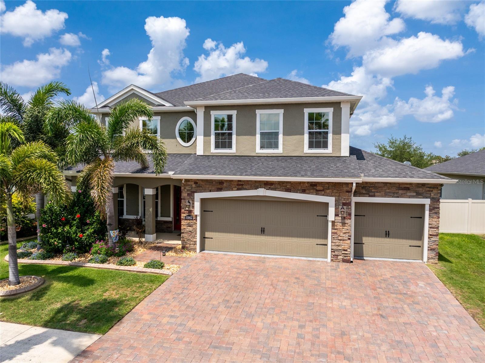 Welcome to this stunning Estero Bay home in the highly sought-after, double-gated side of Lucaya Lake Club — a resort-style community just one-third of a mile from PK-8 Collins Elementary. Offering 5 bedrooms, 2.5 bathrooms, a 3-car garage, and 3,092 sq. ft. of meticulously upgraded living space, this home truly has it all.  From the moment you arrive, the premium lot impresses with a paver driveway, upgraded landscaping with concrete curbing, and integrated French drains. Step through the wrought iron glass front door into a grand interior with tile flooring throughout the first floor, soaring ceilings, 8-foot doors, and premium finishes.  The open layout flows effortlessly from formal living and dining areas into a warm, inviting family room. The chef-inspired kitchen features stainless steel appliances, granite countertops, and extended cabinetry — perfect for a custom coffee bar or extra storage. A flexible first-floor bedroom serves equally well as a private home office or guest suite.  Upstairs, a massive loft offers endless possibilities as a game room, media space, or second living area. The Owner's Suite is a true sanctuary with an elegant tray ceiling, two spacious walk-in closets, and a spa-like en-suite bath with dual vanities, a soaking tub, and a separate shower. Three additional generously sized bedrooms, a full bath, and a convenient laundry room complete the second floor.  This home delivers comfort and serious savings:  Paid-in-full solar system — activated January 2026, producing an average of 61 kWh/day (up to 81 kWh/day), saving $250+/month ($3,000+ annually) at current TECO rates; includes a 10-year craftsmanship warranty and 25-year panel production warranty. Upgraded 14" attic insulation, attic exhaust fan, and professionally tinted windows and doors for maximum climate control and a tankless water heater for endless hot water.  Step outside to a fully fenced, expansive backyard built for year-round Florida entertaining. A sparkling saltwater pool with a brand-new salt cell (installed April 2026) anchors the space, complemented by a screened paver lanai with custom remote-controlled sun shades.  The 3-car garage is fully loaded with epoxy flooring, overhead storage racks, and a utility sink. Hurricane shutters provide total peace of mind.  Living in Lucaya Lake Club means a vacation lifestyle every day. Residents enjoy exclusive access to a 68-acre boatable lake, clubhouse, resort-style pool, splash pad, fitness center, and private beach area. Ideally located south of Tampa, you're just minutes from Apollo Beach, MacDill AFB, Tampa International Airport, and world-class Gulf Coast beaches.