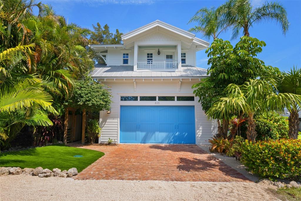 Tropicottage is stunningly located right on the beach with sunrise views over Tampa Bay, this is one of the most unique and breathtaking locations on Anna Maria Island. Newly designer remodeled and refurnished in 2021, Tropicottage welcomes you with joyful island style furnishings and decor, crisp, comfortable bedding, and every amenity to make your stay unforgettable. A relaxing and comfortable getaway ideal for a family or group where you can dine alfresco, sunbathe, play mini golf, swim, and walk the beach. We’ve lovingly remodeled and refurnished this mini compound, with a main house and a guest cottage, as a charming island getaway. Tropicottage is located just minutes to the heart of Anna Maria village with restaurants, bars, and boutiques. Nestled in the quintessential AMI north end neighborhood, this is the perfect place to rent a golf cart and bikes for riding to dine and shop. The home features a lush, tropical courtyard with a heated pool, lounge chairs, outdoor dining and seating areas. Adjacent to the pool is the converted garage, the ultimate man cave with a relaxed, beachy vibe complete with full bar, ping pong table, large flat screen TVs, and comfortable sofa seating area. The main house offers a well-appointed kitchen with all new appliances and an island inspired dining table with seating for 8. The great room is the heart of the home with designer furnishings and doors that open to the beach and your own putting green. Downstairs are two beautifully appointed guest bedrooms and a full guest bath. Wake up to watch the sunrise over the bay in the “orchid room” and walk out the double doors right to the beach. In the downstairs “cloud room” your guests will be delighted by the custom coastal bunk beds with a door that opens to the pool courtyard. The second-floor master bedroom suite includes a king bed with new mattress, en-suite bathroom, desk, TV, balcony overlooking the bay for sipping sunrise coffee, and a large sun deck with lounge chairs and seating, all with sweeping views of the beach and courtyard pool. The guest cottage offers the perfect place for a couple to escape to the private master suite featuring a kitchenette and refrigerator, coffee maker, full bath, and seating with large flat screen TV. Enjoy a cocktail after a day in the sun and take in the breathtaking water views from the guest cottage balcony.