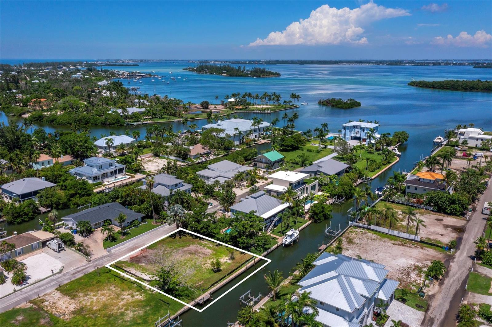 Discover a rare opportunity to build your dream home on north Longboat Key. This 100’ x 100’ lot offers 100 feet of frontage on a serene 37-foot-wide canal with no fixed bridges—perfect for boating, paddle boarding, and kayaking. Enjoy quick access to Sarasota Bay, the Intracoastal Waterway, and the Gulf of Mexico, with a number of popular boat-up restaurants just minutes away.
 
The quiet neighborhood setting is ideal for walking and biking, while kayakers and paddle boarders will appreciate the calm, protected waters leading to Jewfish Key, Beer Can Island, and Sister Keys. Gulf beach access is also close by, making it easy to enjoy the very best of both the Bay and Gulf lifestyle.
 
Just around the corner, you’ll find the charm of Longboat Village with dining favorites such as Mar Vista and Shore, along with Whitney’s, Lazy Lobster, Euphemia Haye, Harry’s Continental Kitchens, and more. This build-ready homesite combines a coveted location, walkability, and waterfront access, offering an unmatched lifestyle on Longboat Key. Call for more information.