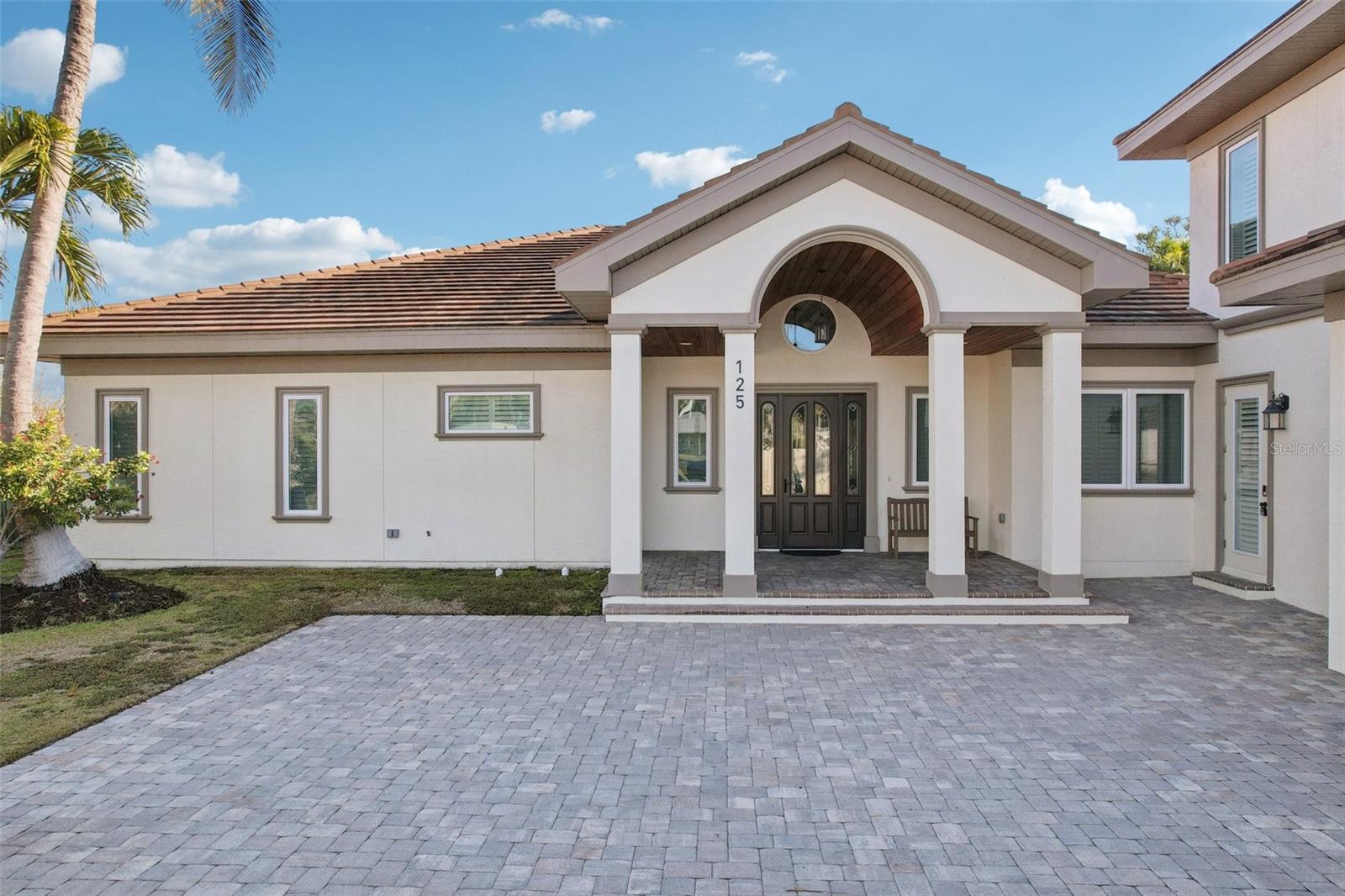 Experience luxury island living in this beautifully appointed 5-bedroom, 5.5-bath retreat located just moments from the world-famous St. Armands Circle and Lido Beach. Designed for both relaxation and entertaining, this spacious home offers an exceptional blend of elegant interiors and resort-style outdoor living.

The heart of the home is the stunning gourmet kitchen, featuring premium appliances, custom cabinetry, expansive quartz countertops, a gas cooktop, wine refrigeration, and 2 large center islands perfect for gathering with family and friends. The open-concept living area boasts soaring ceilings, abundant natural light, and walls of sliding glass doors that seamlessly connect indoor and outdoor spaces.

Step outside to your private tropical oasis, complete with a heated screened pool and spa, covered lanai, comfortable outdoor lounge seating, dining area, and a fully equipped outdoor kitchen and grill station. Whether you're enjoying morning coffee poolside, hosting an evening barbecue, or unwinding after a day at the beach, this home is designed to make every moment memorable.

Located near the shops, restaurants, and vibrant atmosphere of St. Armands Circle, and just minutes from the white sand beaches of Lido Key, this exceptional property offers the perfect Sarasota vacation experience.