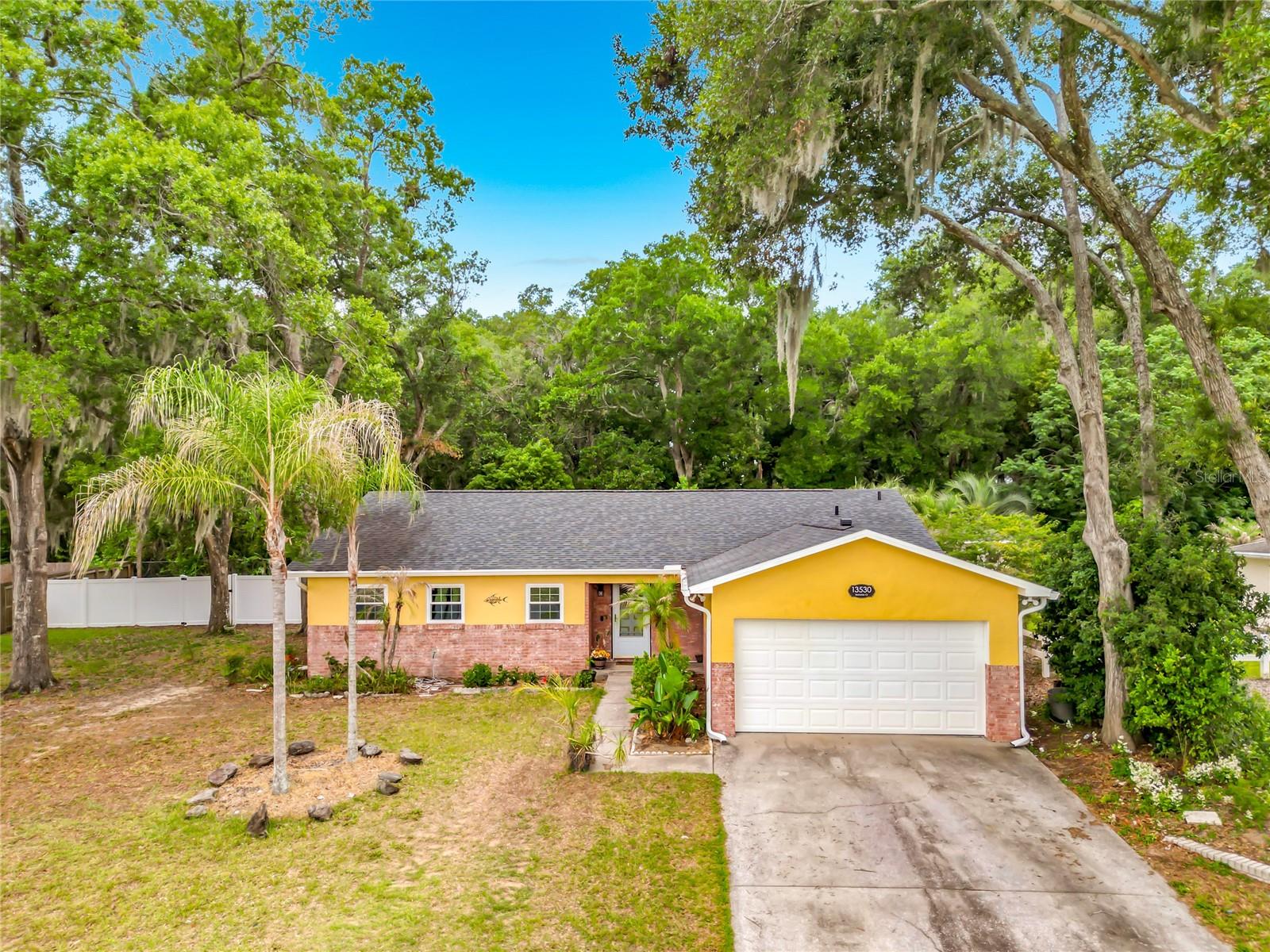 Welcome to this charming home nestled in the quiet neighborhood of Brendenwood! Situated on an oversized lot with mature landscaping and beautiful oak trees, this property offers privacy, comfort, and timeless appeal — all with no HOA restrictions. Step inside to find a warm and inviting interior featuring parquet, carpet, and linoleum flooring throughout. The spacious living area is highlighted by a cozy wood-burning fireplace, creating the perfect gathering space for relaxing evenings at home. The kitchen is designed with functionality in mind, offering solid surface countertops, a pantry, and abundant customized storage cabinets. The primary suite provides a peaceful retreat with walk-in closets and a private ensuite bath. Enjoy outdoor living in the fully fenced private yard complete with a gazebo and screened rear porch — ideal for entertaining, gardening, or simply unwinding in your own backyard oasis. This unfurnished property combines comfort, character, and convenience in a beautiful Brendenwood setting.