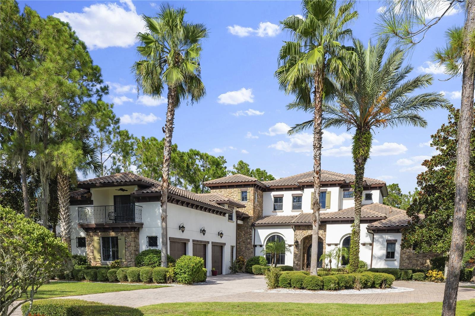 Luxury Living in Bella Collina!! Experience the ultimate in Central Florida luxury at this Mediterranean-inspired estate built by renowned Master Custom Builder, Stonebridge Custom Homes in the exclusive guard-gated community of Bella Collina. This single-story residence offers 5,878 sq. ft. of sophisticated living space on a private 1.3-acre lot, featuring 5 bedrooms, 6.5 bathrooms, and an above-garage in-law suite with kitchenette for guests or extended family. Inside, architectural details take center stage—soaring ceilings with intricate tray and coffered designs, arched doorways, elegant stonework, and expansive windows that bathe each room in natural light. Entertain in style with a game room and full bar, a chef’s kitchen overlooking the gathering room, and seamless indoor-outdoor flow. Step outside to a covered lanai with fireplace, perfect for year-round Florida living, along with a private pool and hot tub for ultimate relaxation.As a Bella Collina resident, enjoy world-class amenities including a Nick Faldo–designed golf course, resort pool, tennis courts, full-service spa, fine dining, and 75,000 sq. ft. clubhouse— all set against a backdrop of rolling hills reminiscent of the Italian countryside. Schedule your private tour today and experience this one-of-a-kind estate.