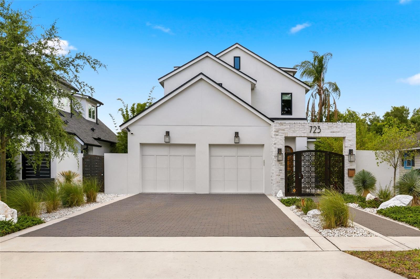 Built by Clarkson Concepts and ideally located in the heart of Winter Park just moments from Park Avenue, this sophisticated modern residence blends luxury design, smart-home innovation, and effortless indoor-outdoor living across three thoughtfully designed levels. From the moment you arrive, the striking foyer makes a memorable first impression with its bold geometric detailing, designer finishes, and contemporary ambiance that immediately sets the tone for the home.
Beyond the entry, the main living spaces unfold into an open-concept kitchen, dining, and living area designed for both everyday comfort and elevated entertaining. The chef’s kitchen is beautifully appointed with custom cabinetry, a Wolf stove, Bosch dishwasher, a premium side-by-side True Residential refrigerator and wine column combination, and a separate under-island beverage refrigerator designed for effortless entertaining. Expansive PGT sliding doors connect the interior spaces seamlessly to the lanai and outdoor retreat, while the Klipsch 5.1 surround sound system, electric fireplace, Anderson windows, ceiling fans, and integrated Elon smart-home system enhance the experience throughout the home.

The outdoor living area was designed as a private modern zen-inspired escape, featuring a fully air-conditioned and heated lanai with cedar-lined ceilings, rolled screens, and direct access to the serene backyard retreat complete with a four-person sauna. Thoughtfully integrated technology and upgrades include Jellyfish lighting, Nest cameras, power-over-Ethernet shades, leak protection system, water filtration systems including Aqua Sauna Water Filter and Kohler Connect Water Minder, as well as two separate AC units serving each floor independently.

The first floor also offers a private guest suite, ideal for visitors or multigenerational living. Upstairs, the second level features a spacious laundry room, two additional en-suite bedrooms, and an impressive primary suite designed as a true retreat. The luxurious primary bathroom showcases a standing shower with digital water controls, dual sinks with custom storage cabinetry, and an expansive custom walk-in closet. Additional highlights throughout the home include engineered wood flooring, electric blinds, and refined designer details at every turn.

Crowning the residence is a spacious third-floor bonus area offering endless flexibility for a media room, fitness studio, office, or additional lounge space, all fully air-conditioned for year-round comfort. Combining exceptional craftsmanship, advanced smart-home functionality, and an unbeatable Winter Park location with exceptional proximity to both Park Avenue and Winter Park Village, this extraordinary residence places premier dining, boutique shopping, cafés, entertainment, and everyday conveniences just moments from home while delivering a truly elevated lifestyle experience.